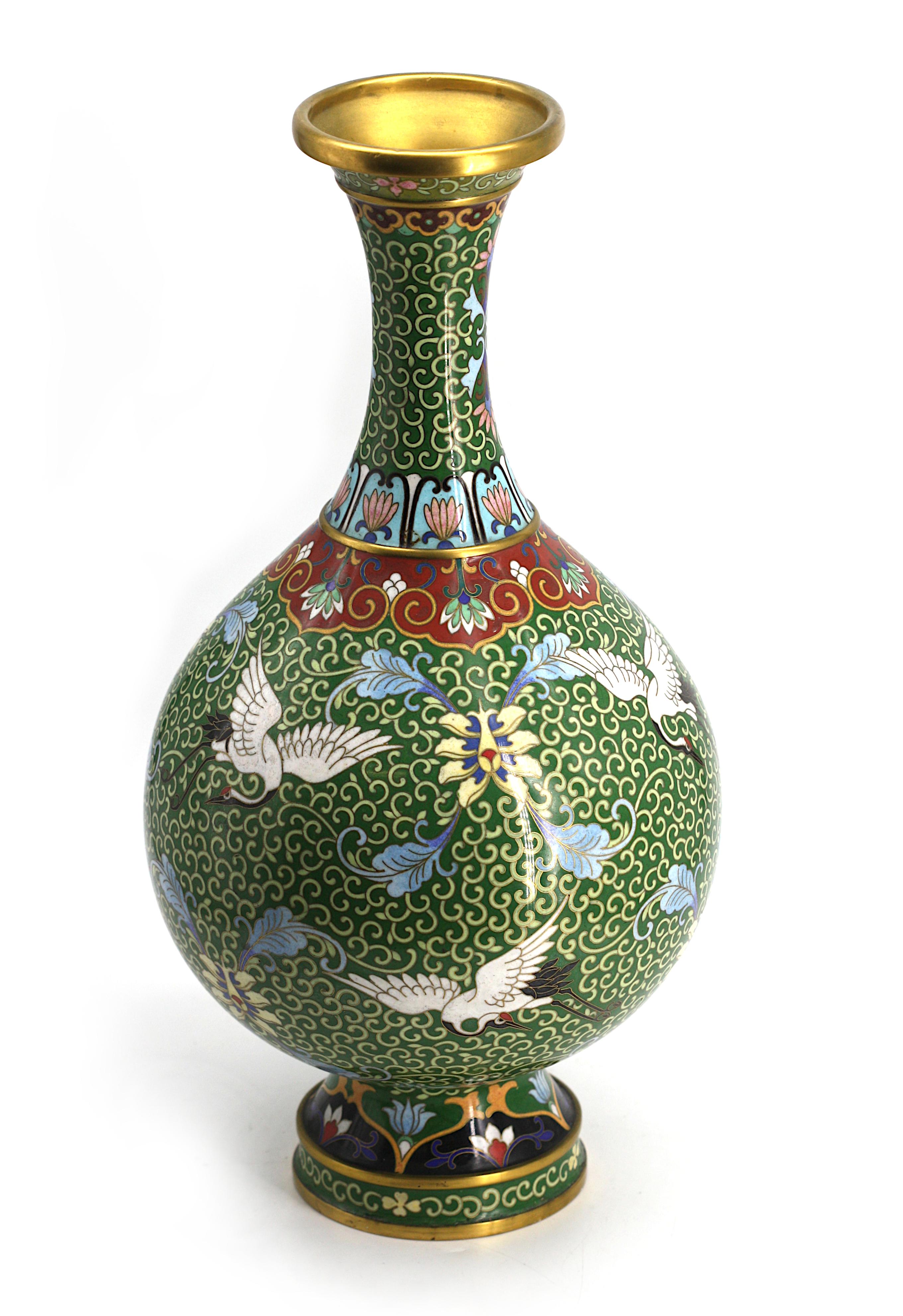 
Chinese Cloisonne Enamel Vase
The spherical body with a long cylindrical neck, on a raised circular foot, decorated with cranes and foliage on a green ground.
Height 15.5 in. Diameter 7.5 in.
Condition Report
Good condition.
