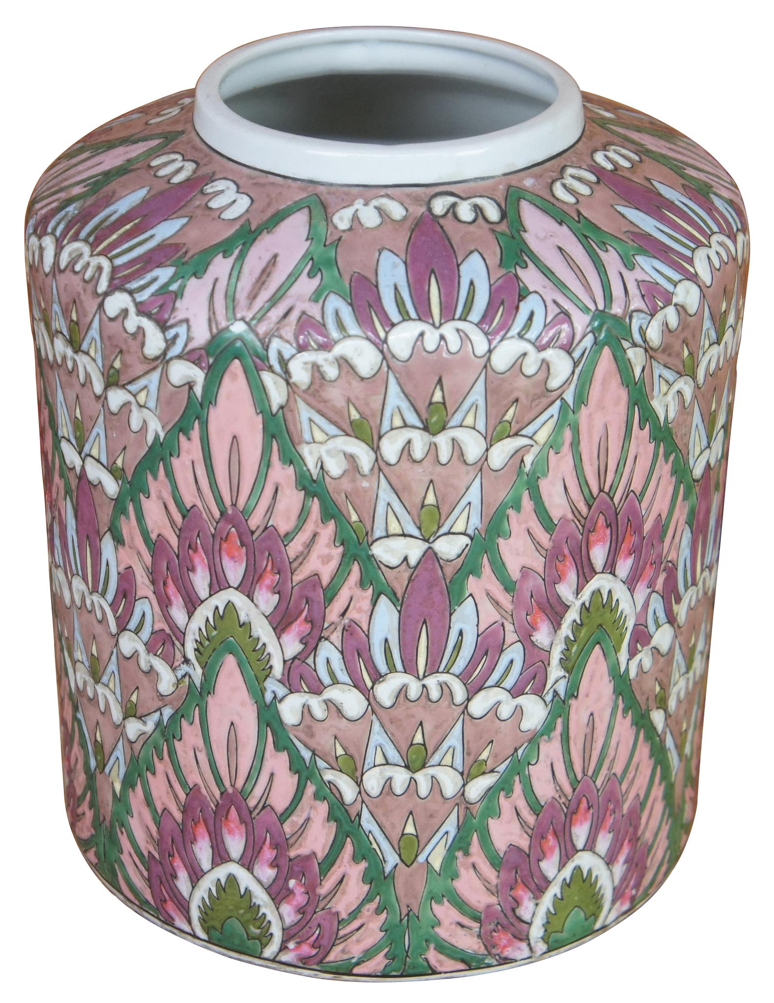 Vintage round Chinese Fammille inspired ceramic vase or ginger jar with a repeating design of pink, green, purple, and blue stack lotus flowers. Measure: 9