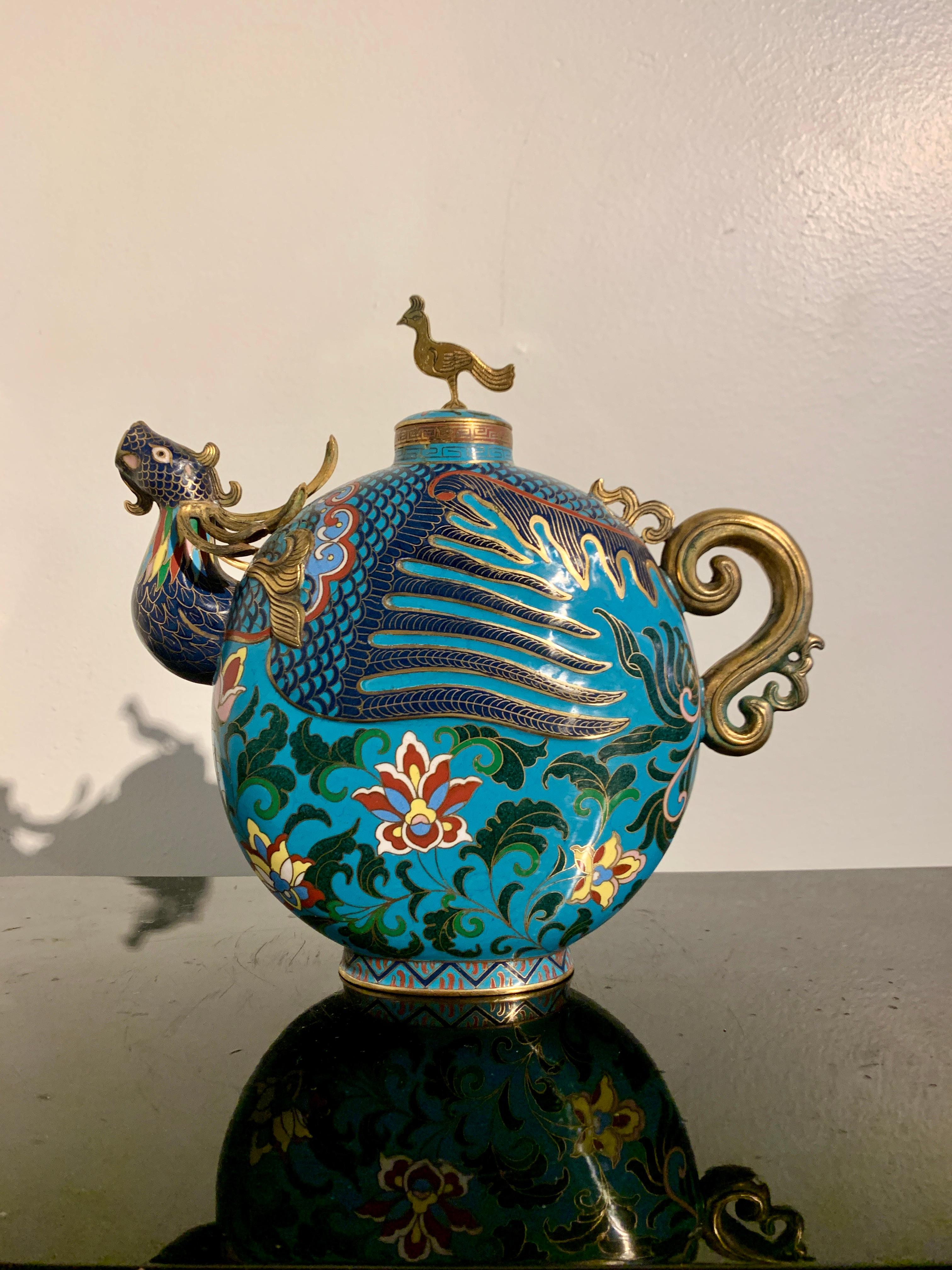 A delightful and unusual Chinese cloisonne enamel copper wine or tea pot in the form of a phoenix, late Republic Period, or post Republic, mid 20th century, China.

The wine pot in the form of a tea pot with a phoenix head spout, reminiscent of the