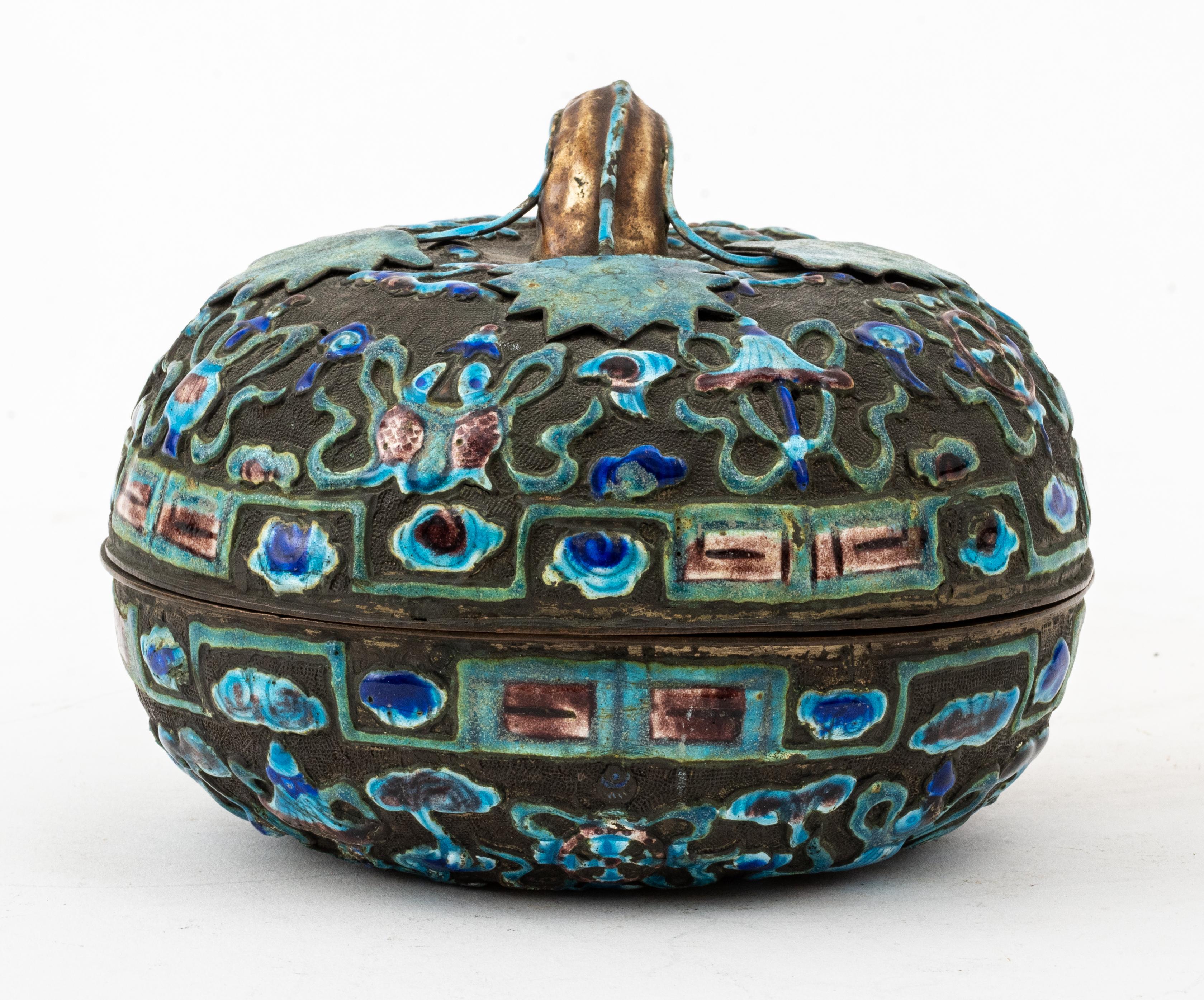 Chinese cloisonné covered box of pumpkin gourd form, with multiple blue enamels and purple enamel formed in scrolling foliate design with flowers, fish, and bats, mark to underside. 

Measures: 4.4