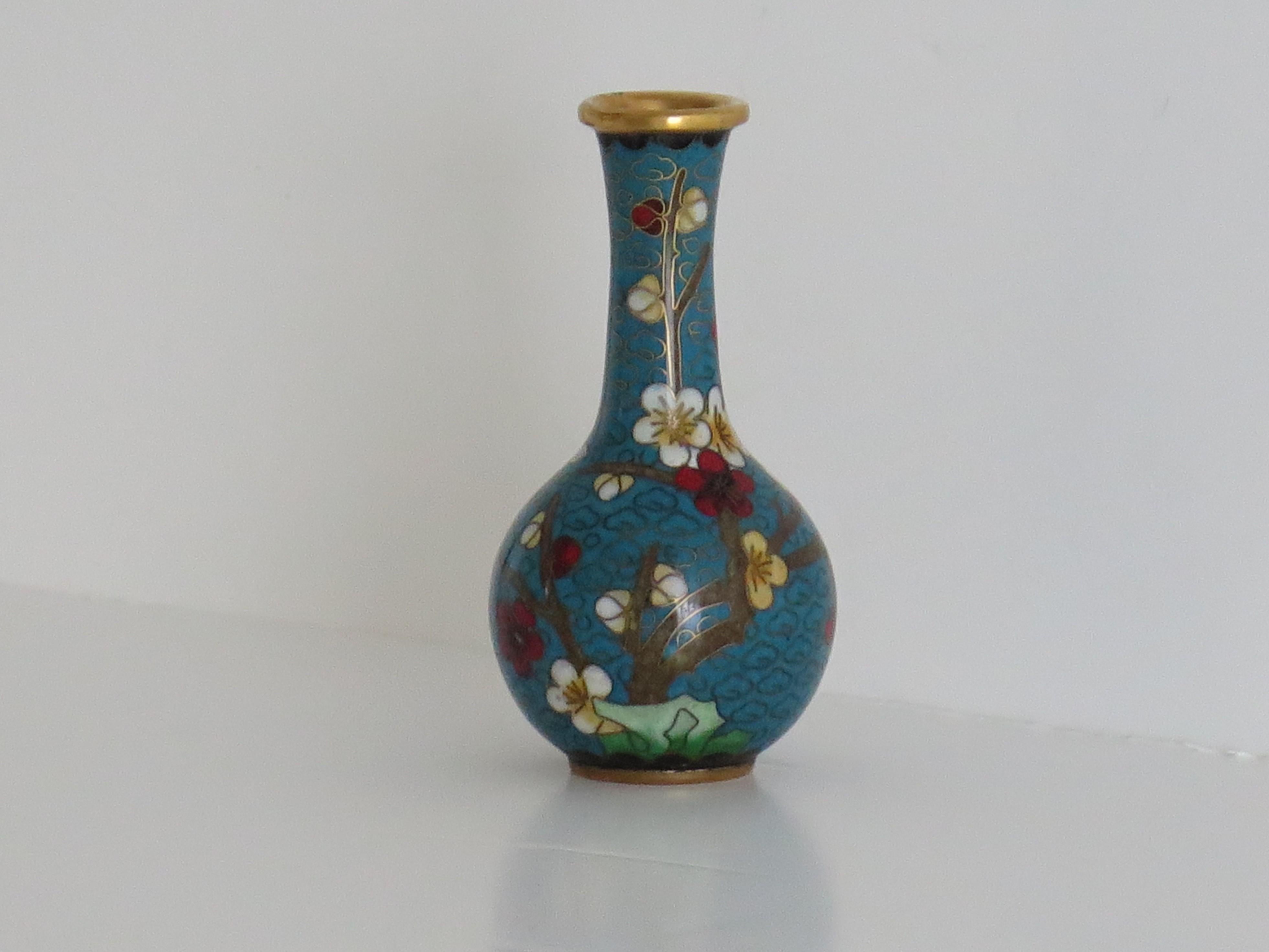 This is a very decorative small cloisonné vase, made in China and dating to the first quarter of the 20th Century. 

The vase has a good globular baluster shape. It has been well made of a bronze alloy with rich enamels of many different colours,
