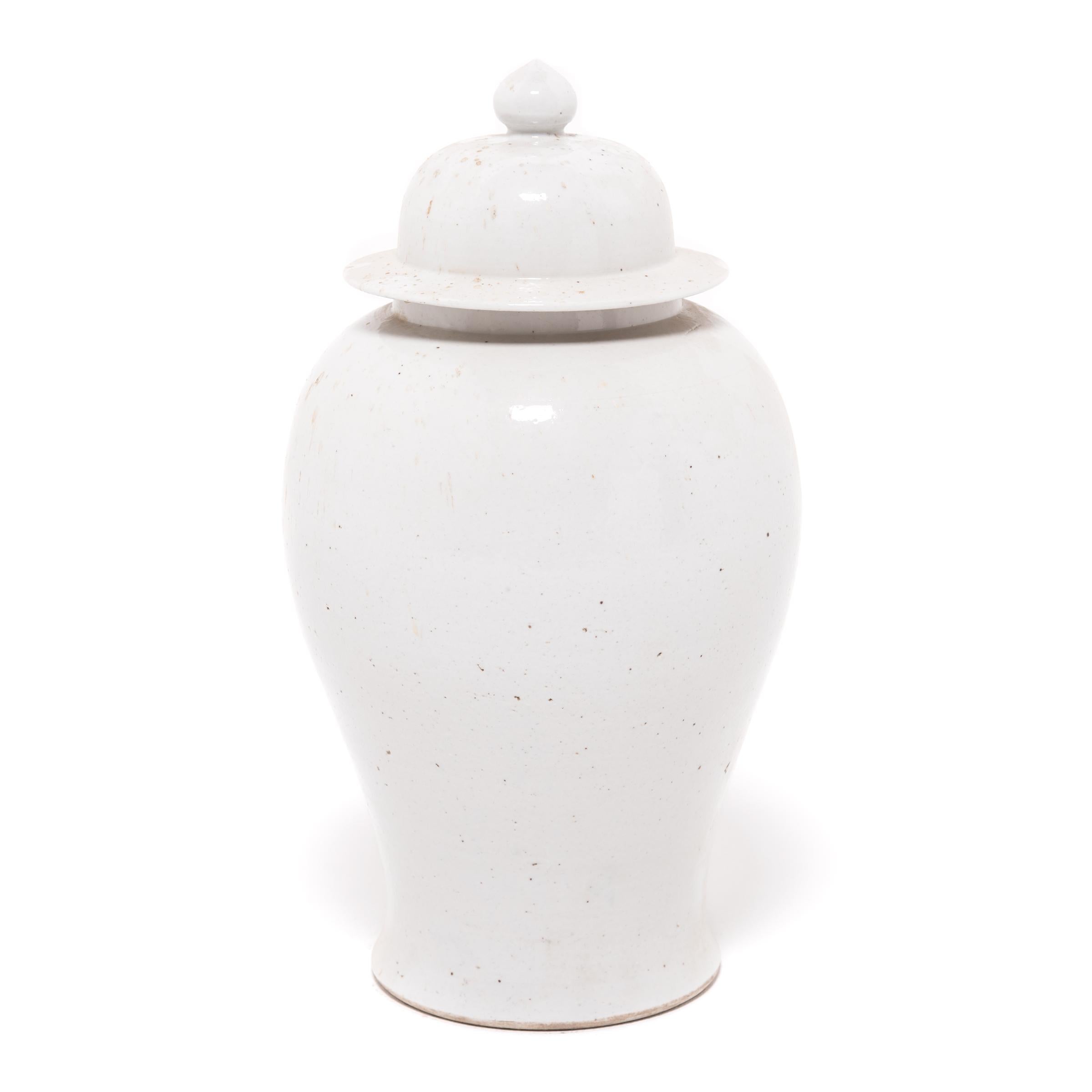 Defined by its rounded body, high shoulders, and domed lid, the time-honored form of the Chinese baluster jar takes on a streamlined look in this contemporary interpretation made in China's Zhejiang province. Traditionally elaborately decorated,
