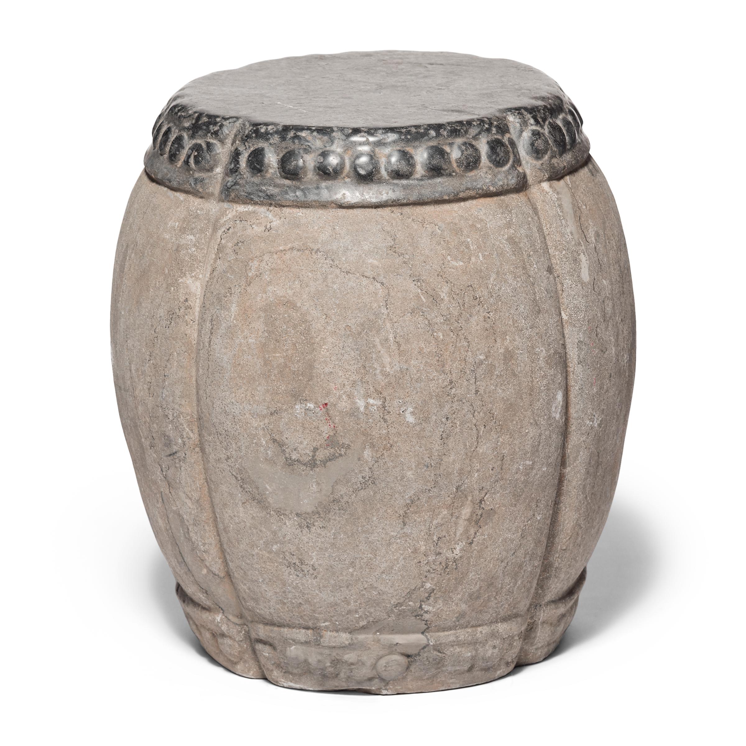 Marked by expressive veining, this handsome stool was carved in China’s Shanxi province out of a piece of solid limestone. Ribbed and rounded, the stool suggests a melon, an ancient Chinese symbol of perpetuity. A pattern of boss-head nails ringing