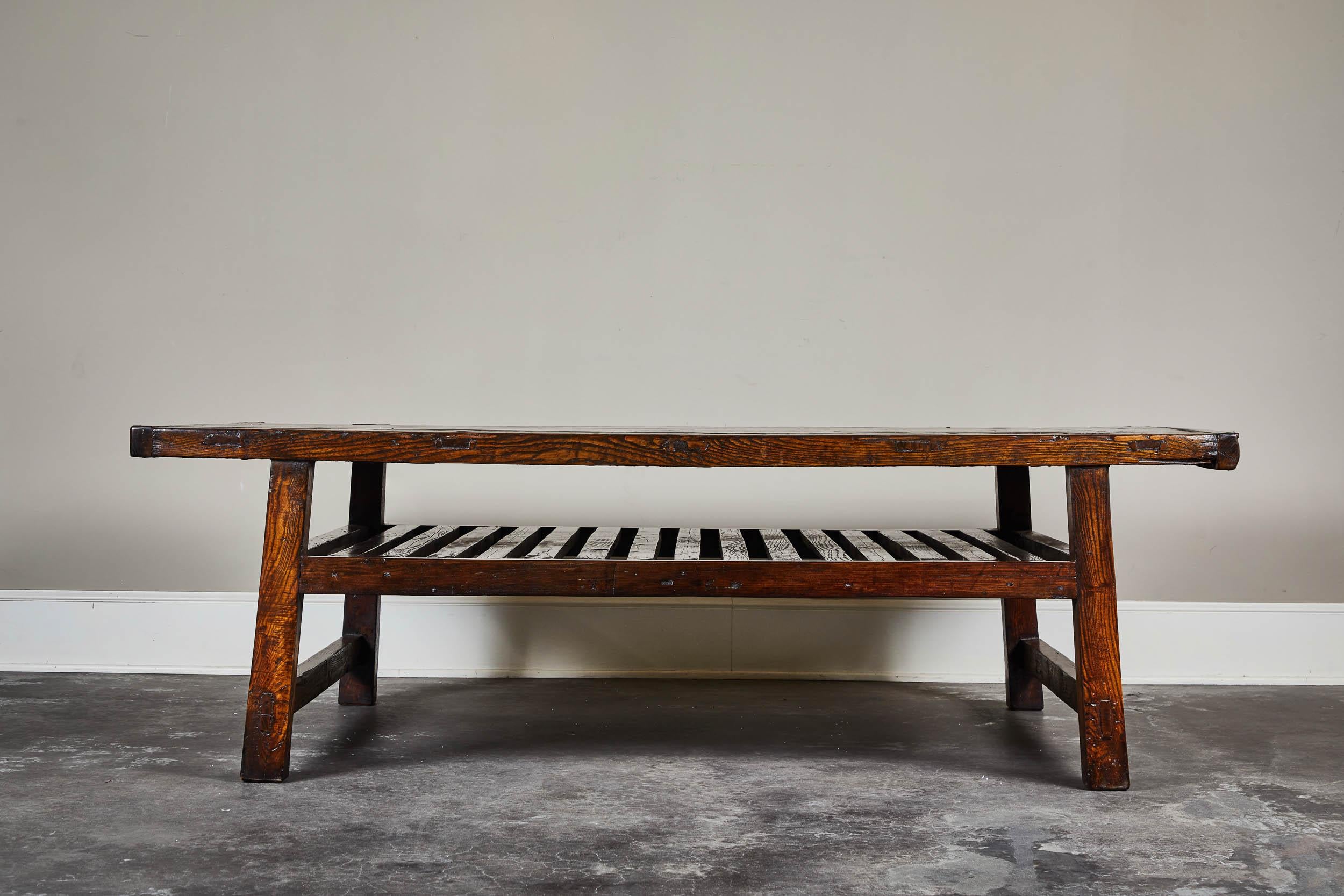 One of a kind low coffee table with one slatted shelf and bookmatched top panels from Shantung.