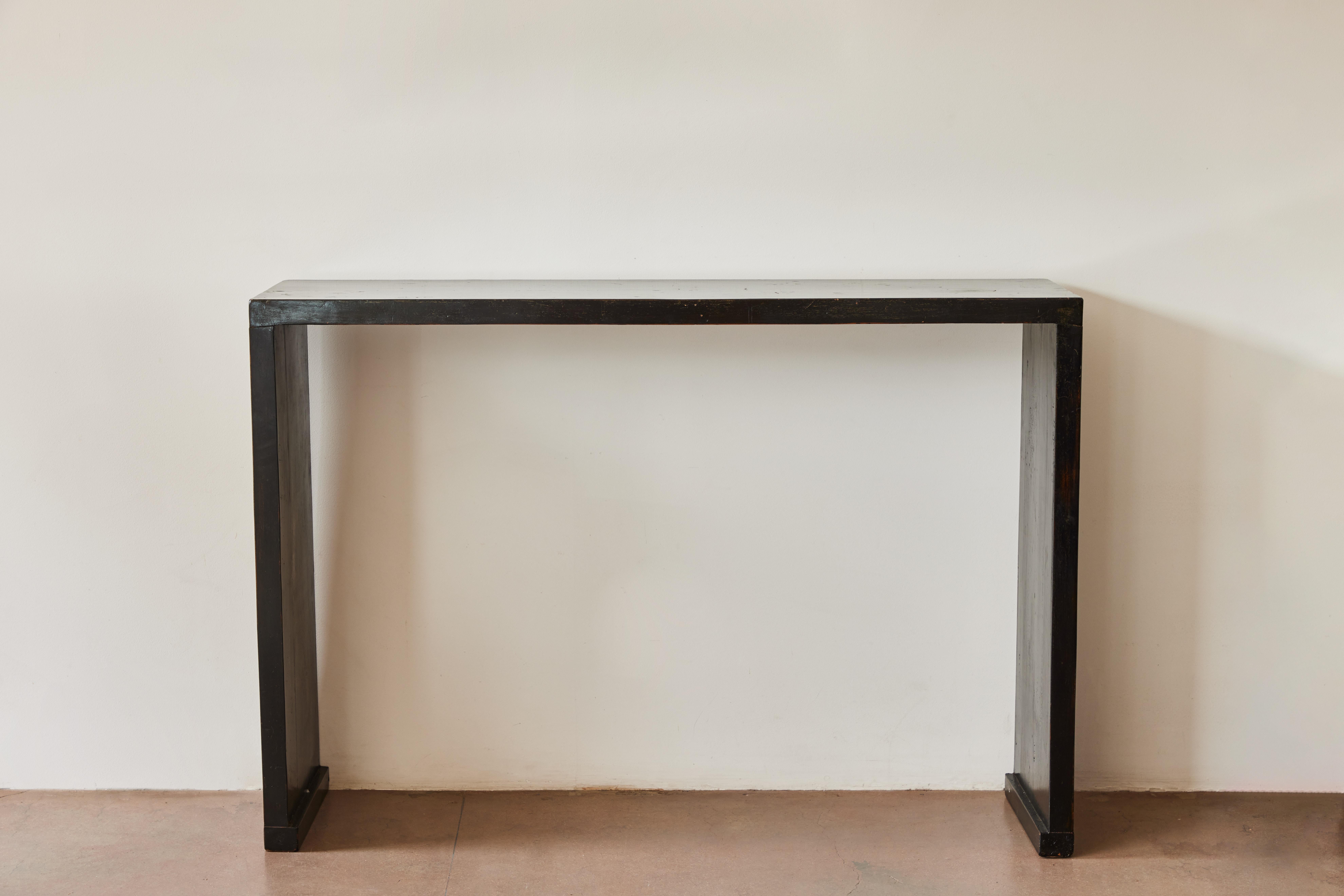 Console table in black lacquered wood. Made in China circa early 20th century. Two available.