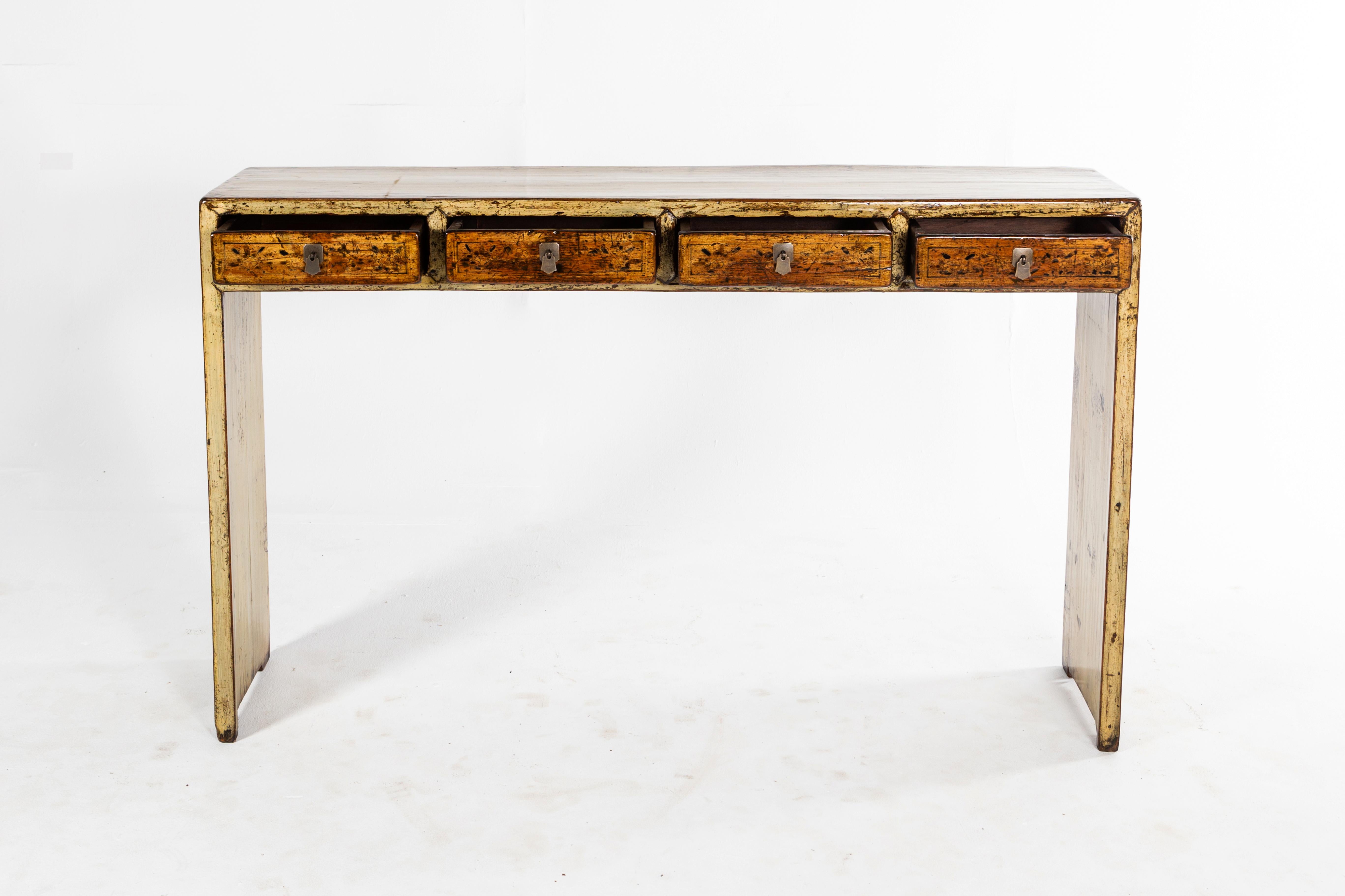 This handsome console table is from Dongbei, China and was made from pine and elm, circa 1920. The piece features 4 drawers and a beautifully aged patina. Wear consistent with age and use.