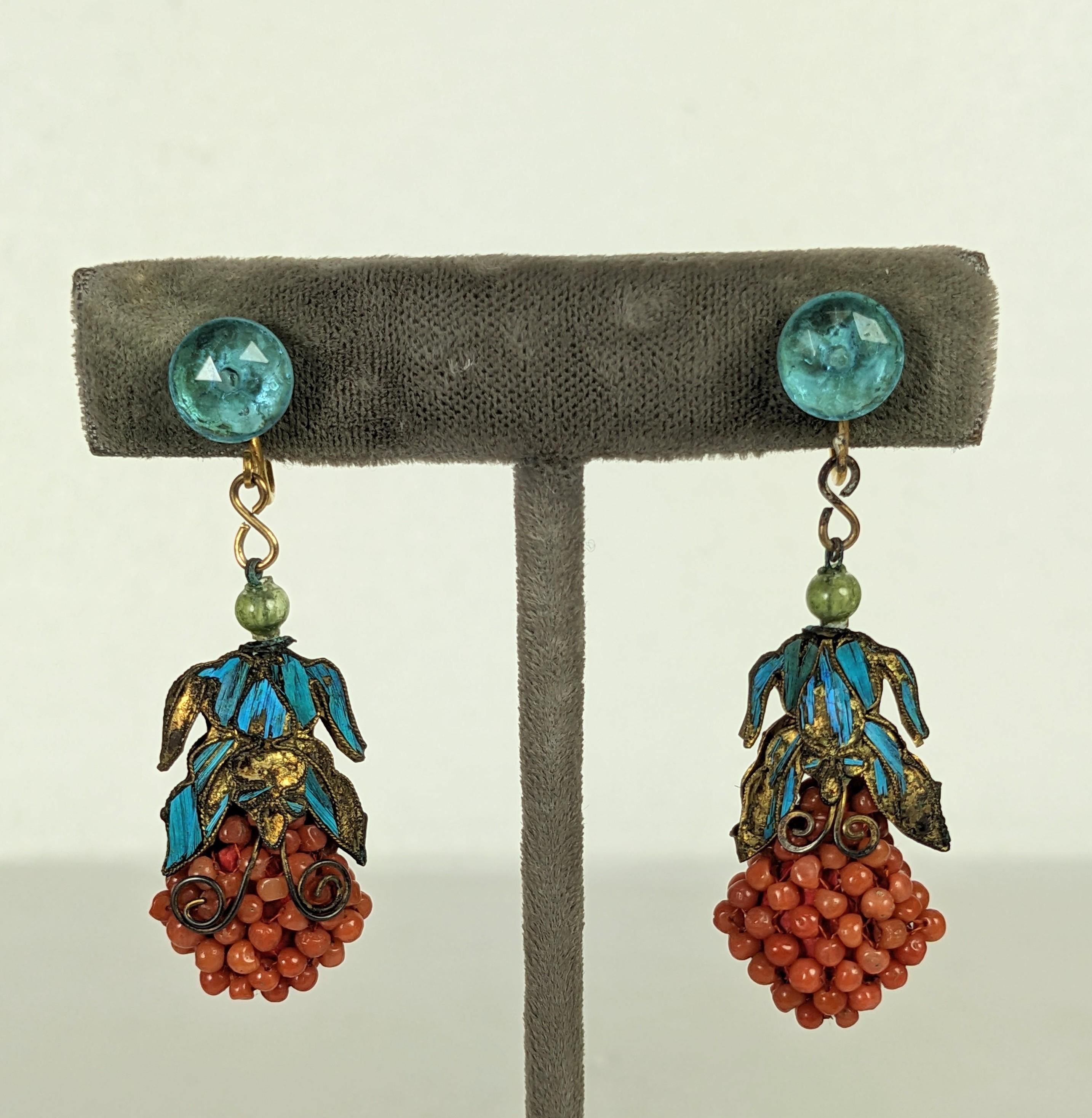 Striking Chinese Coral and Kingfisher Feather Deco Drop Earrings circa 1920's. An aquamarine crystal screw back earring has a drop of woven coral beads. The drop is capped with butterfly motifs set with kingfisher feathers in that brilliant
