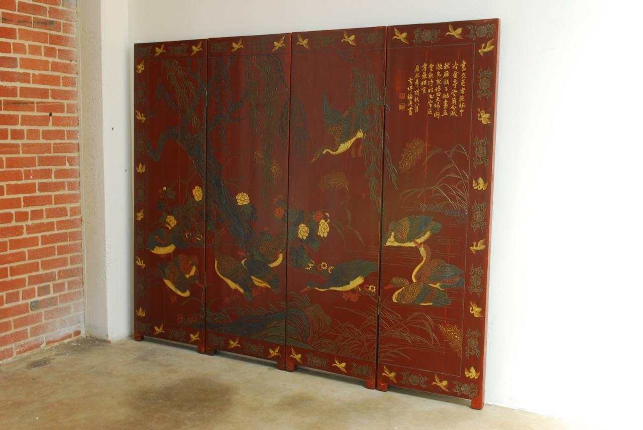 Distinctive Chinese two-sided lacquer carved screen of ducks and geese landscape. Made in a Coromandel style with carved scenes on the front and painted windows on the reverse side in black lacquer. Thick 1.75