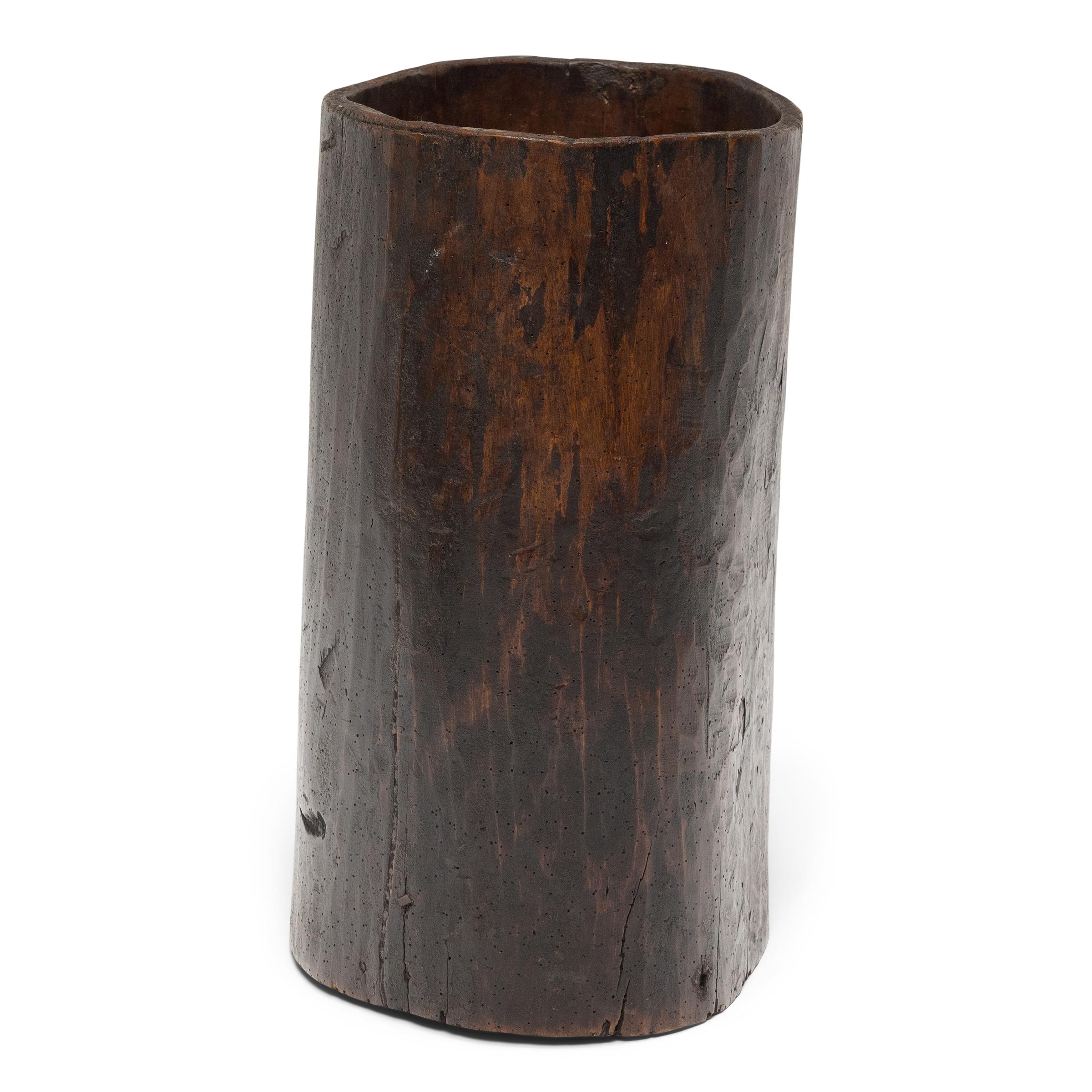 This rustic wooden container dates to the early 20th century and was once used to store dry goods or household items in a provincial home in Yunnan province. Hollowed from a single tree trunk, the wide container has an organic, asymmetrical form and