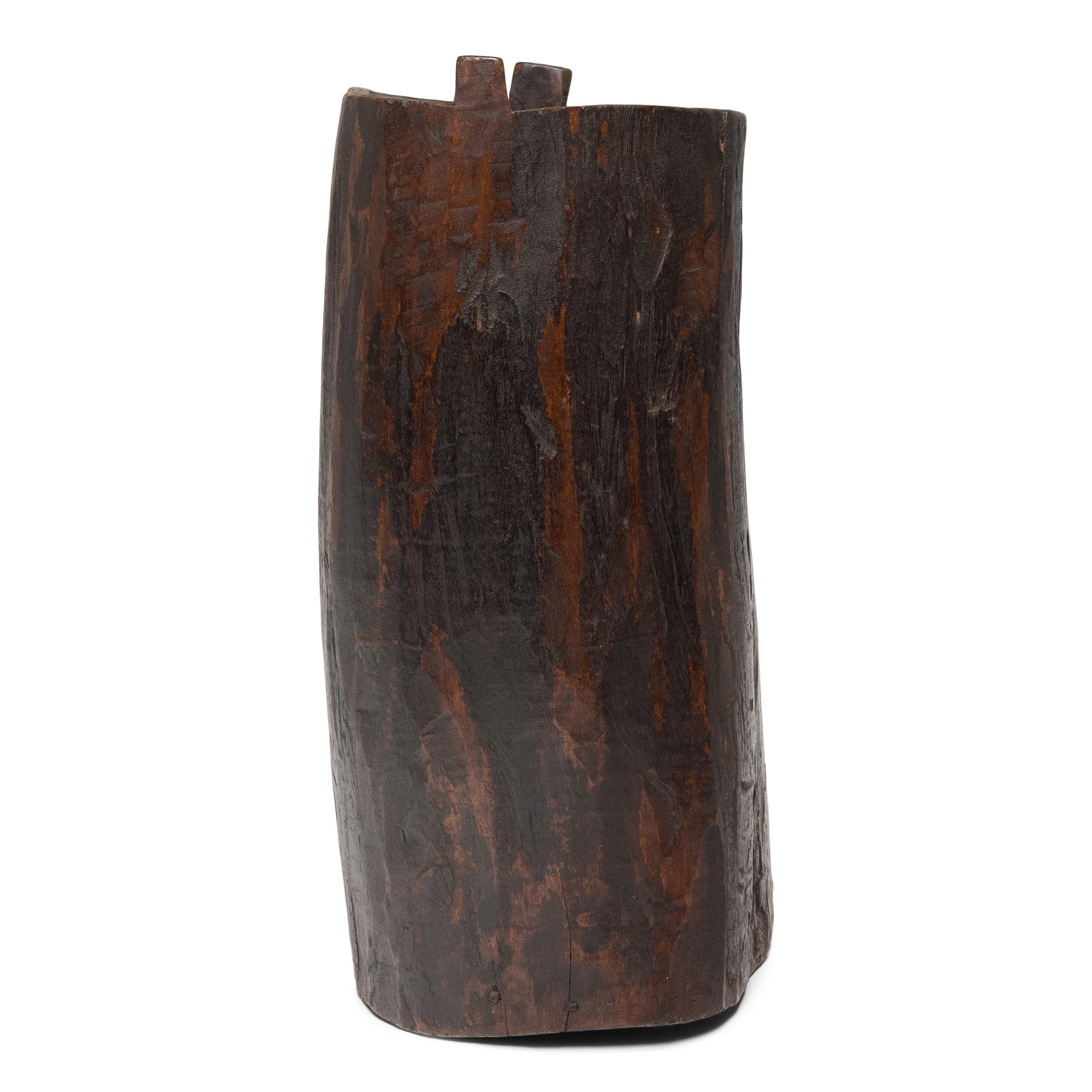 This rustic wooden container dates to the early 20th century and was once used to store dry goods or household items in a provincial home in Yunnan province. Hollowed from a single tree trunk, the wide container has an organic, asymmetrical form and