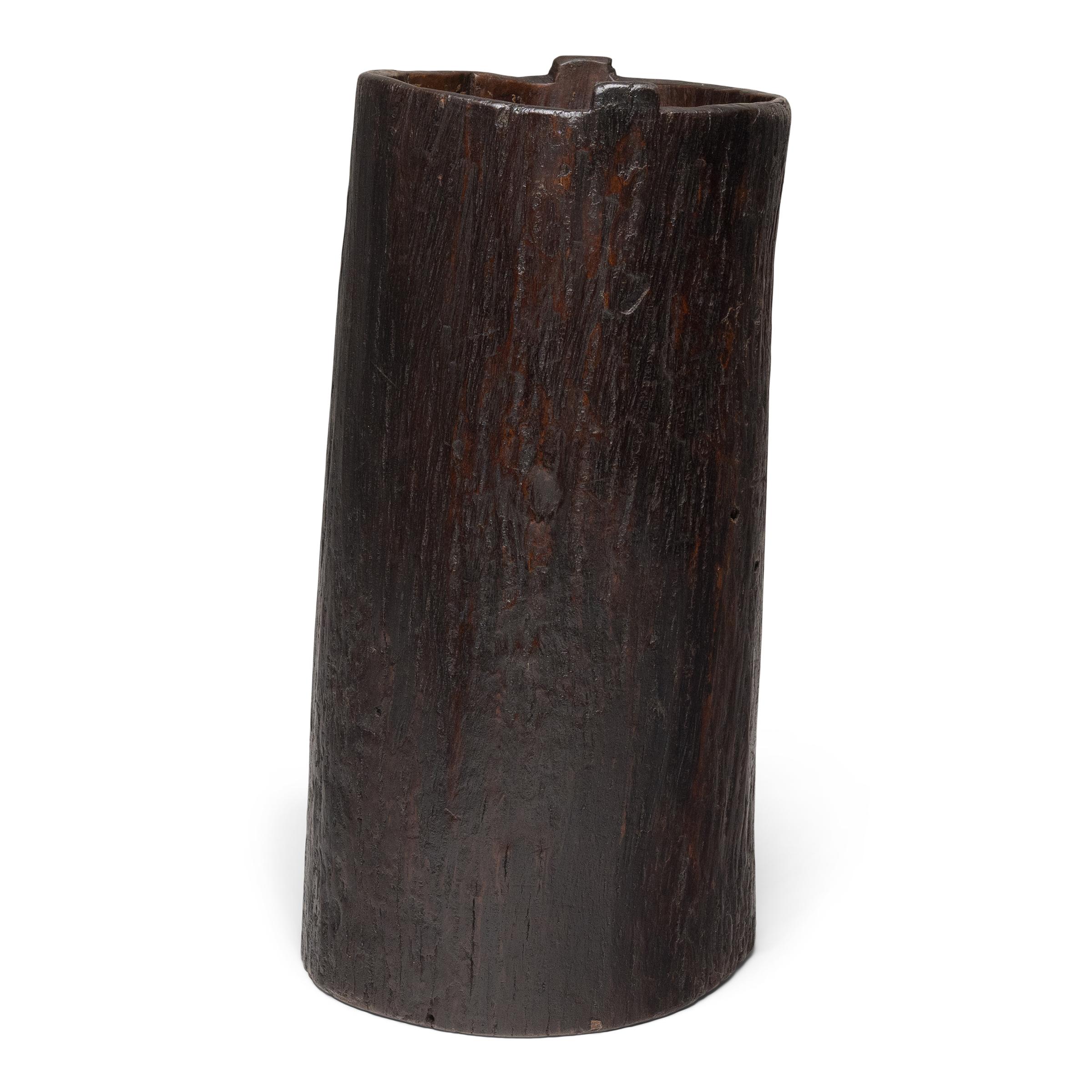 This rustic wooden container dates to the early 20th century and was once used to store dry goods or household items in a provincial home in Yunnan province. Hollowed from a single tree trunk, the wide container has an organic, asymmetrical form and