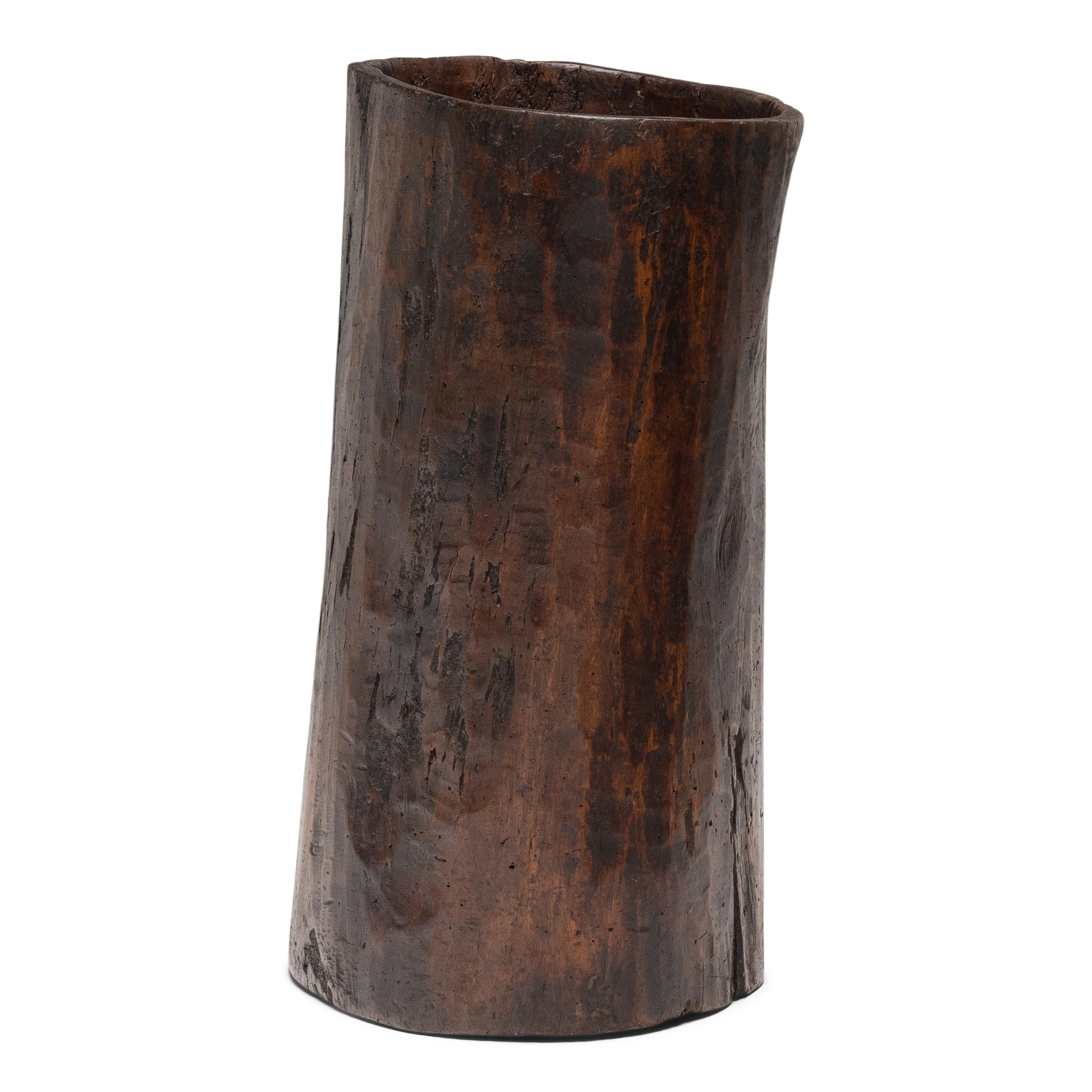 This rustic wooden container dates to the early 20th century and was once used to store dry goods or household items in a provincial home in Yunnan province. Hollowed from a single tree trunk, the wide container has an organic, asymmetrical form and
