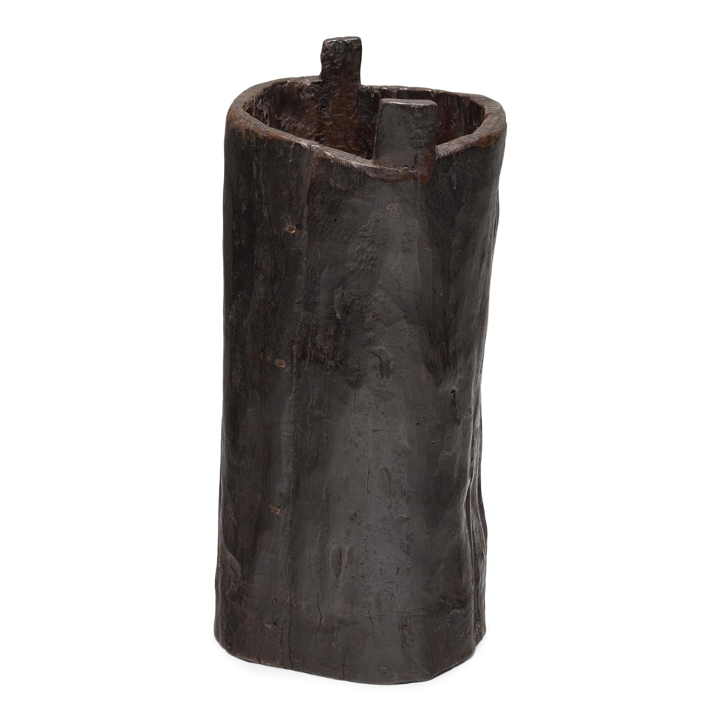 This rustic wooden container dates to the early 20th century and was once used to store dry goods or household items in a provincial home in Yunnan province. Hollowed from a single tree trunk, the wide container has an organic, asymmetrical form and