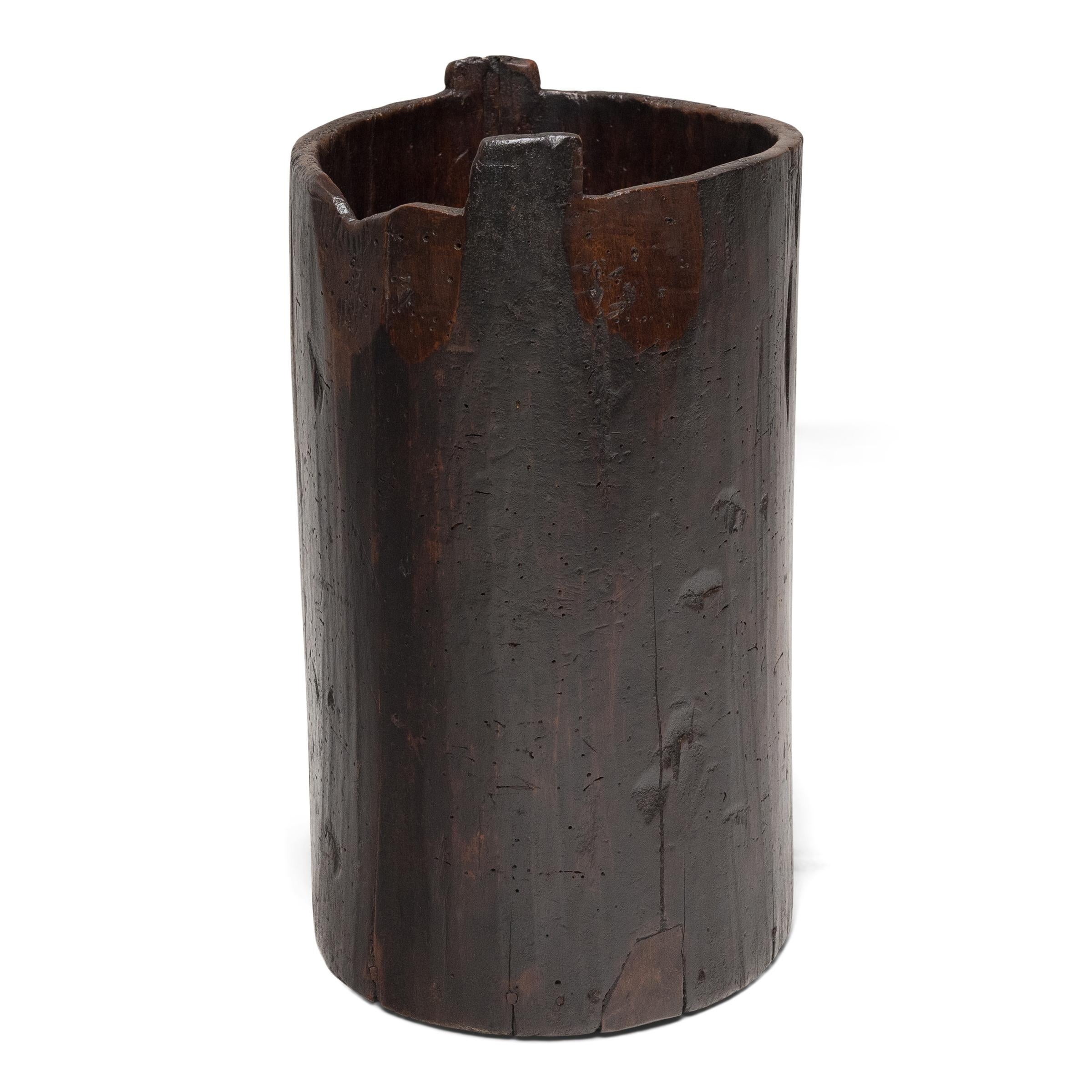 This rustic wooden container dates to the early 20th century and was once used to store dry goods or household items in a provincial home in Yunnan province. Hollowed from a single tree trunk, the wide container has an organic, asymmetrical form and