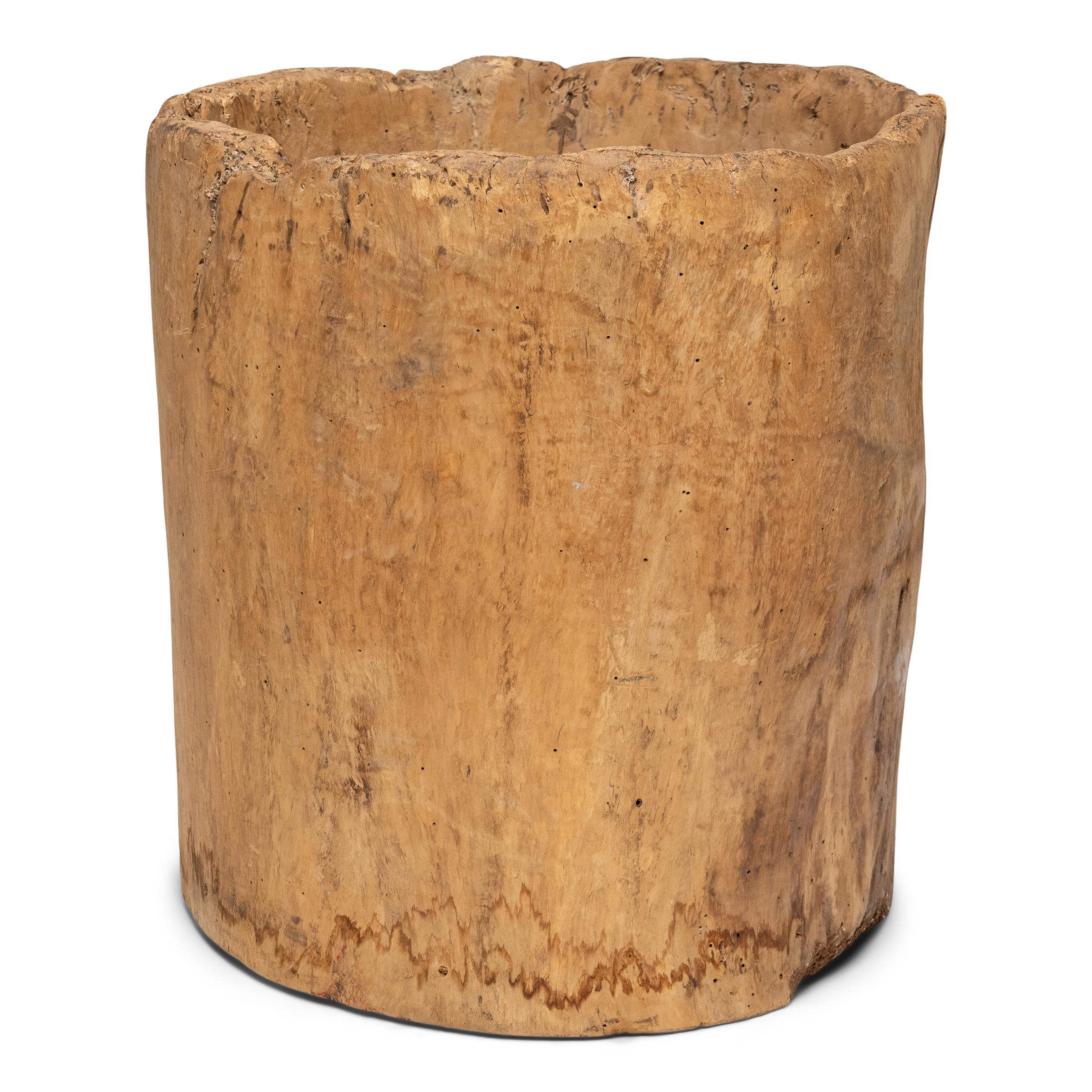 This rustic wooden container dates to the early 20th century and was once used to store dry goods or household items in a provincial home in Yunnan province. Hollowed from a single fir tree trunk, the wide container has an organic, asymmetrical