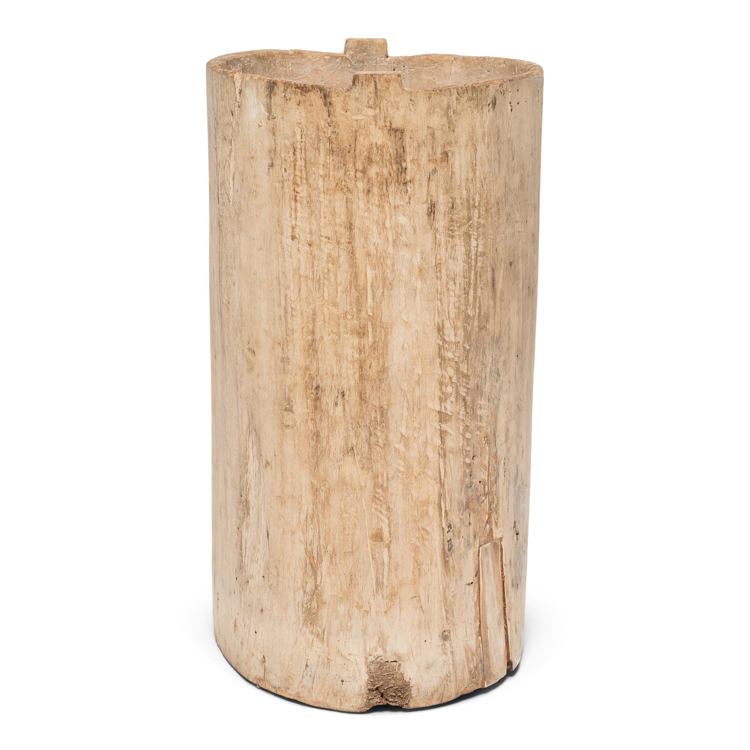 This rustic wooden container dates to the early 20th century and was once used to store dry goods or household items in a provincial home in Yunnan province. Hollowed from a single tree trunk, the wide container has an organic, asymmetrical form and