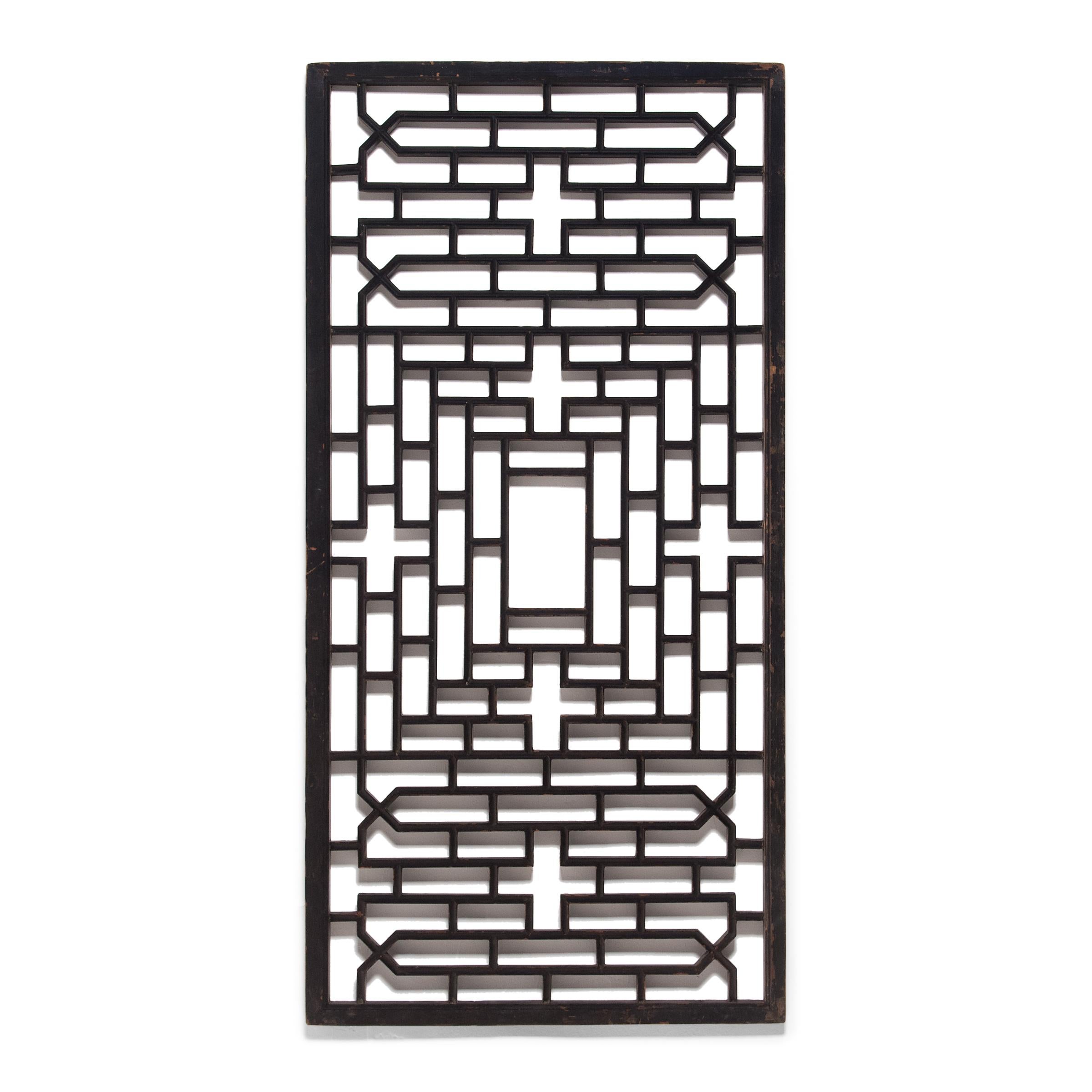 This early 20th century lattice window panel originated in Zhejiang province and once overlooked the interior courtyard of an aristocratic Chinese home. The geometric lattice pattern is linear and open, and was designed to allow light and fresh air