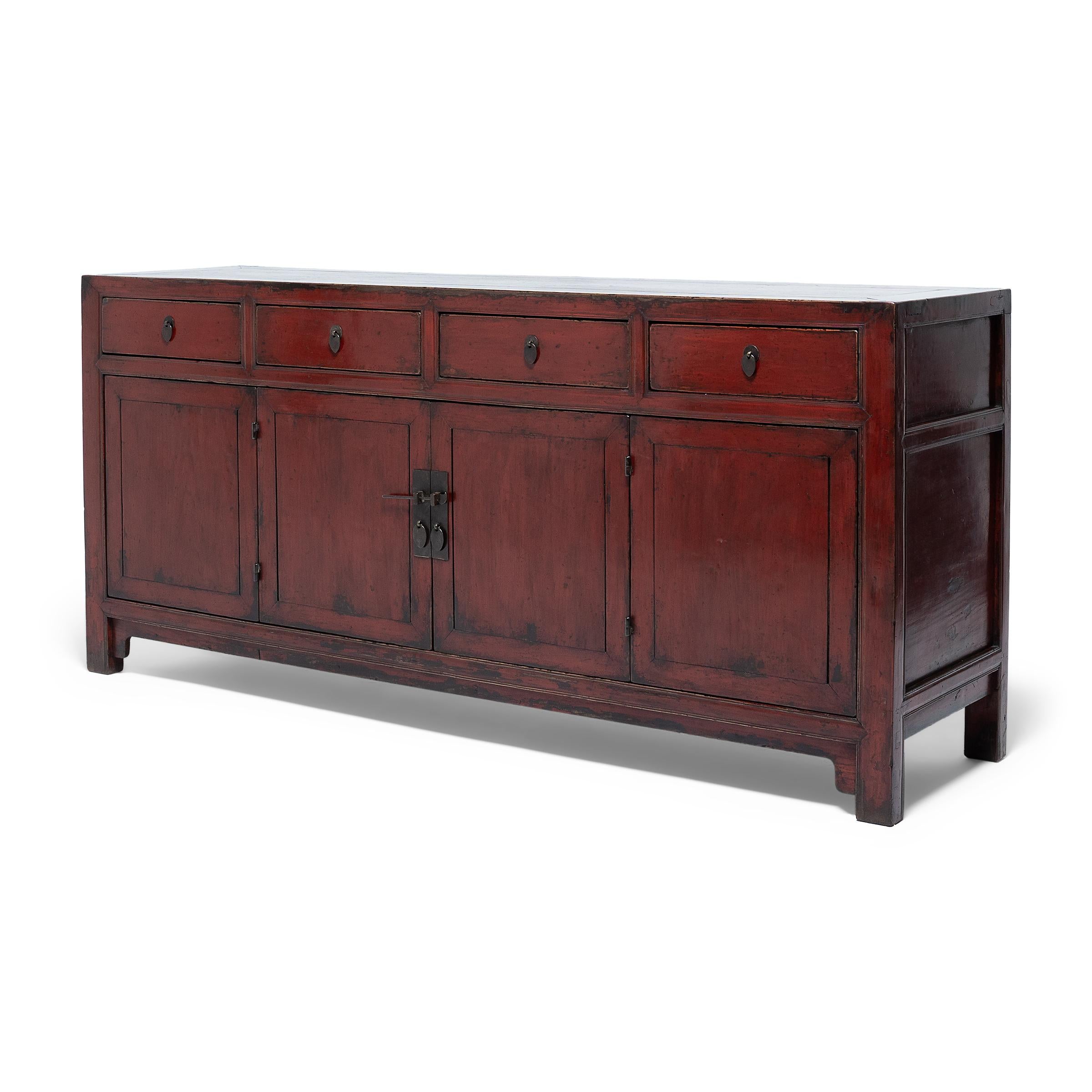 This Provincial coffer from northern China has a simple, clean-lined form finished with layers of black and cinnabar-red lacquer. The coffer dates to the early 19th Century and is expertly crafted of northern elm (yumu) using traditional