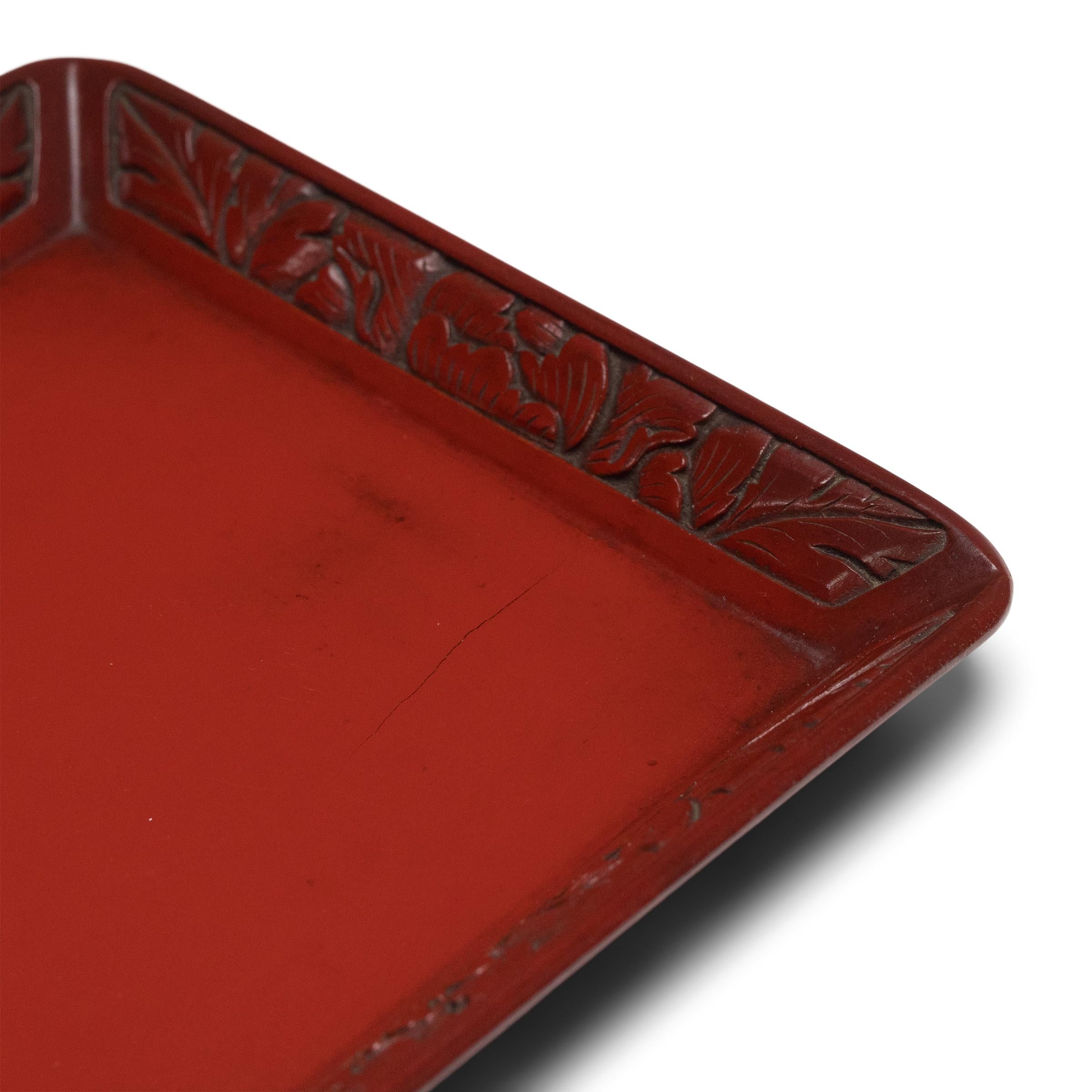 This delicate serving tray dates to the early 19th century and brings a sophisticated restraint to the opulence of Qing-dynasty lacquerware. The simple, rectangular form is enlivened by vibrant finish of cinnabar-red lacquer, meticulously applied