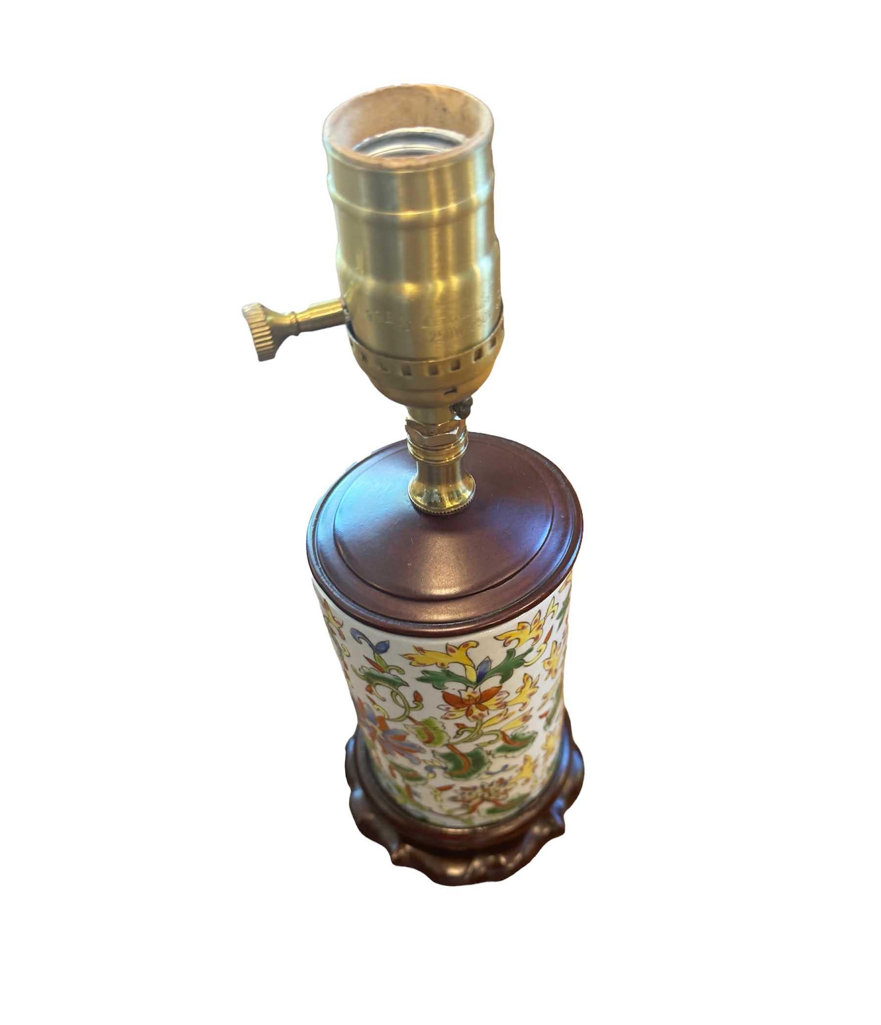 Embrace the allure of history and culture with this remarkable antique Chinese famille rose cylinder vase lamp. Crafted with exquisite artistry, this piece showcases intricate designs in vibrant colors typical of the famille rose style. Adorning the