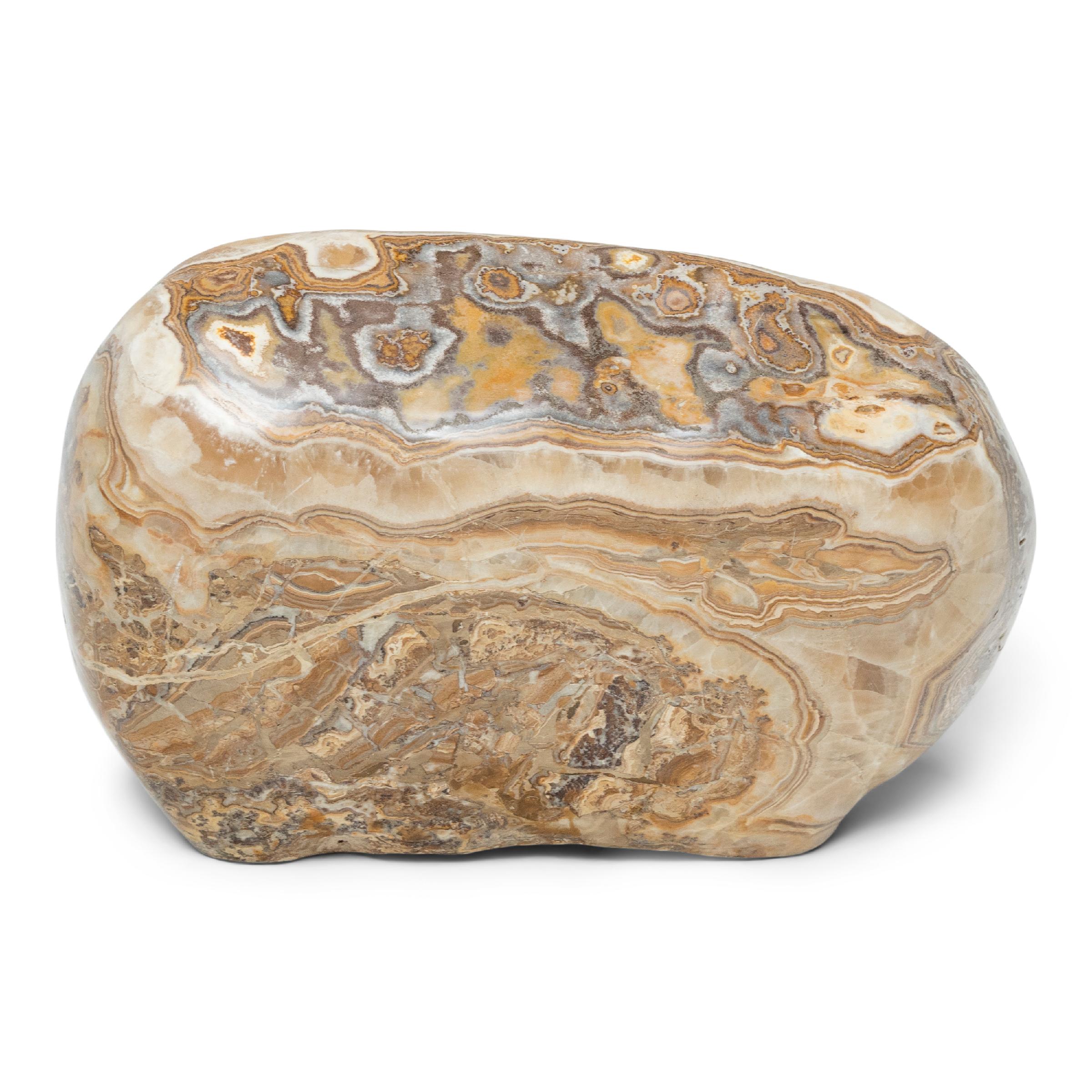 Following the sculpted form, marbled coloring, and natural veining of this one-of-a-kind stone can be deeply meditative. Viewed as a source of beauty and creativity, Chinese scholar-artists would decorate their studios and gardens with similar