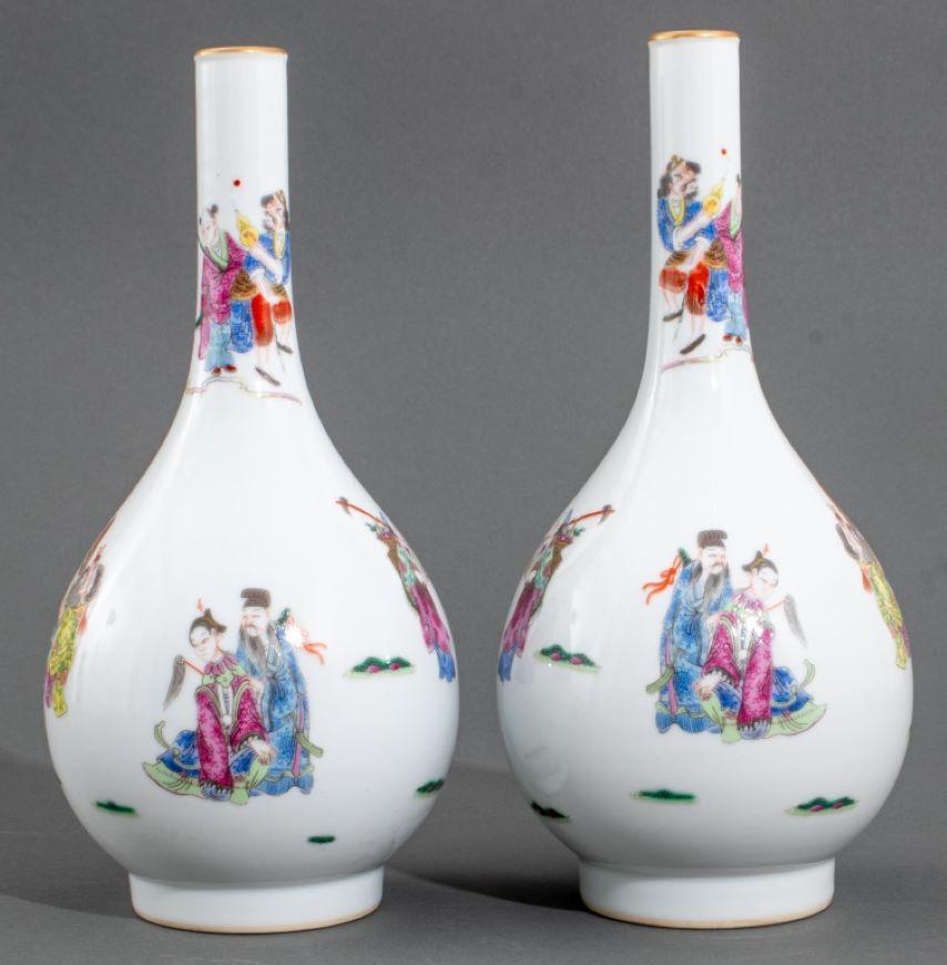 Pair of Chinese Famille Rose Porcelain Immortal Motif Vases, each with iron red six character Daoguang mark to underside, Dan ping forms with gilt-painted rims and hand-painted figures. Each: 11.25