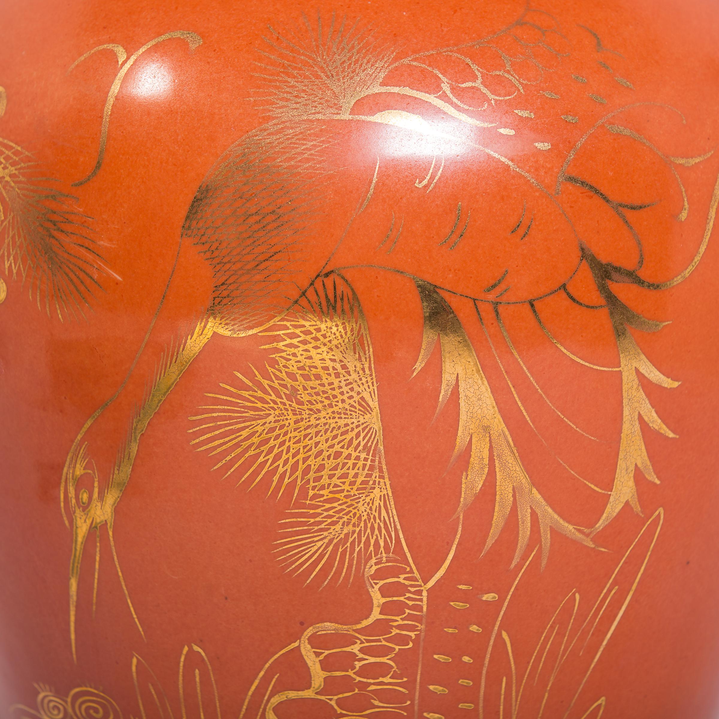 Drawing on the enduring baluster form, this lidded jar from circa 1920 exhibits the sinuous line and gilded refinement that helped to define the global Art Deco movement. Cloaked in a vibrant persimmon glaze, the jar is painted with auspicious