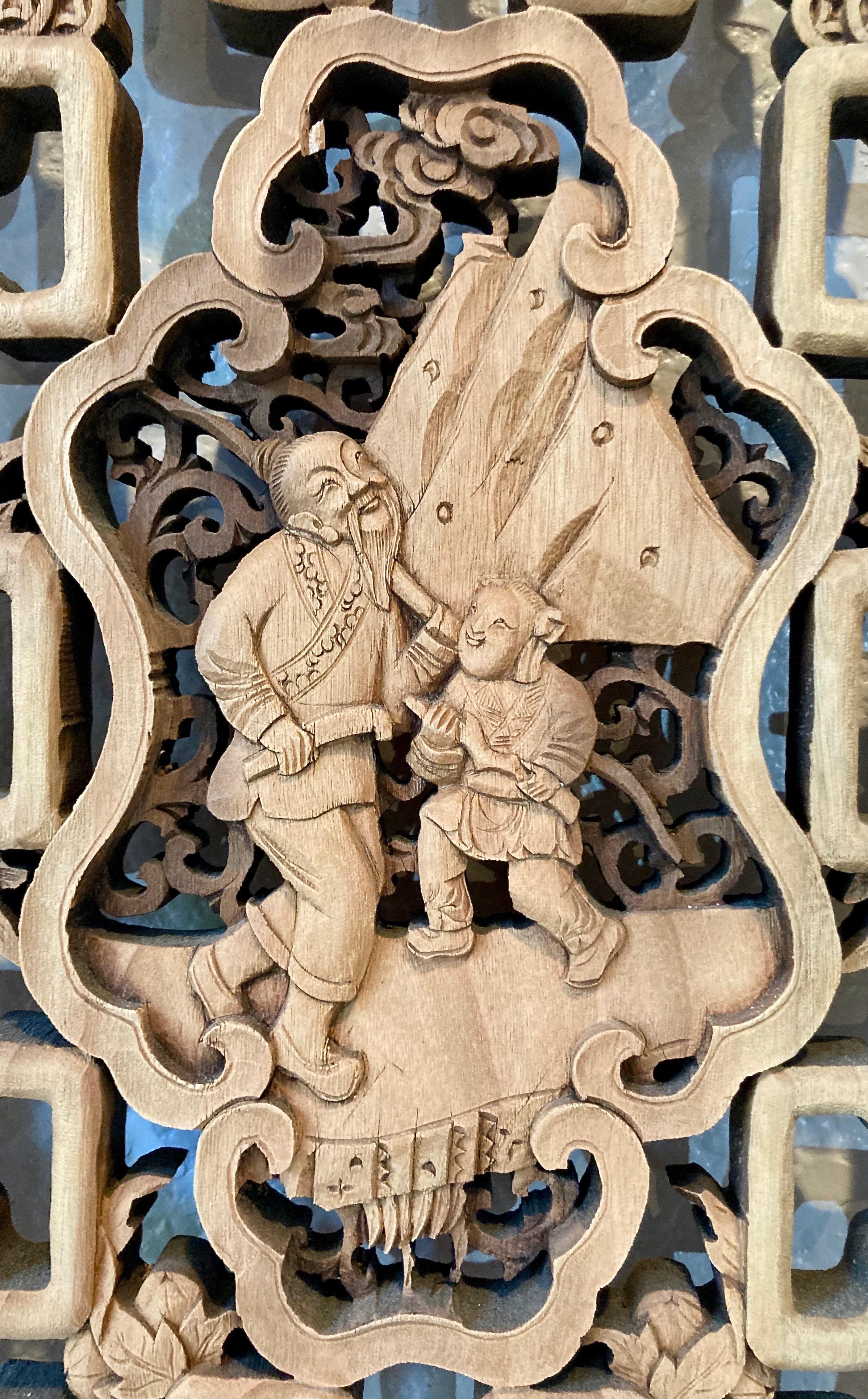 The finely detailed design in this Chinese decorative framed panel has an irregular shaped center carving with personage, surrounding floral and coin motifs.