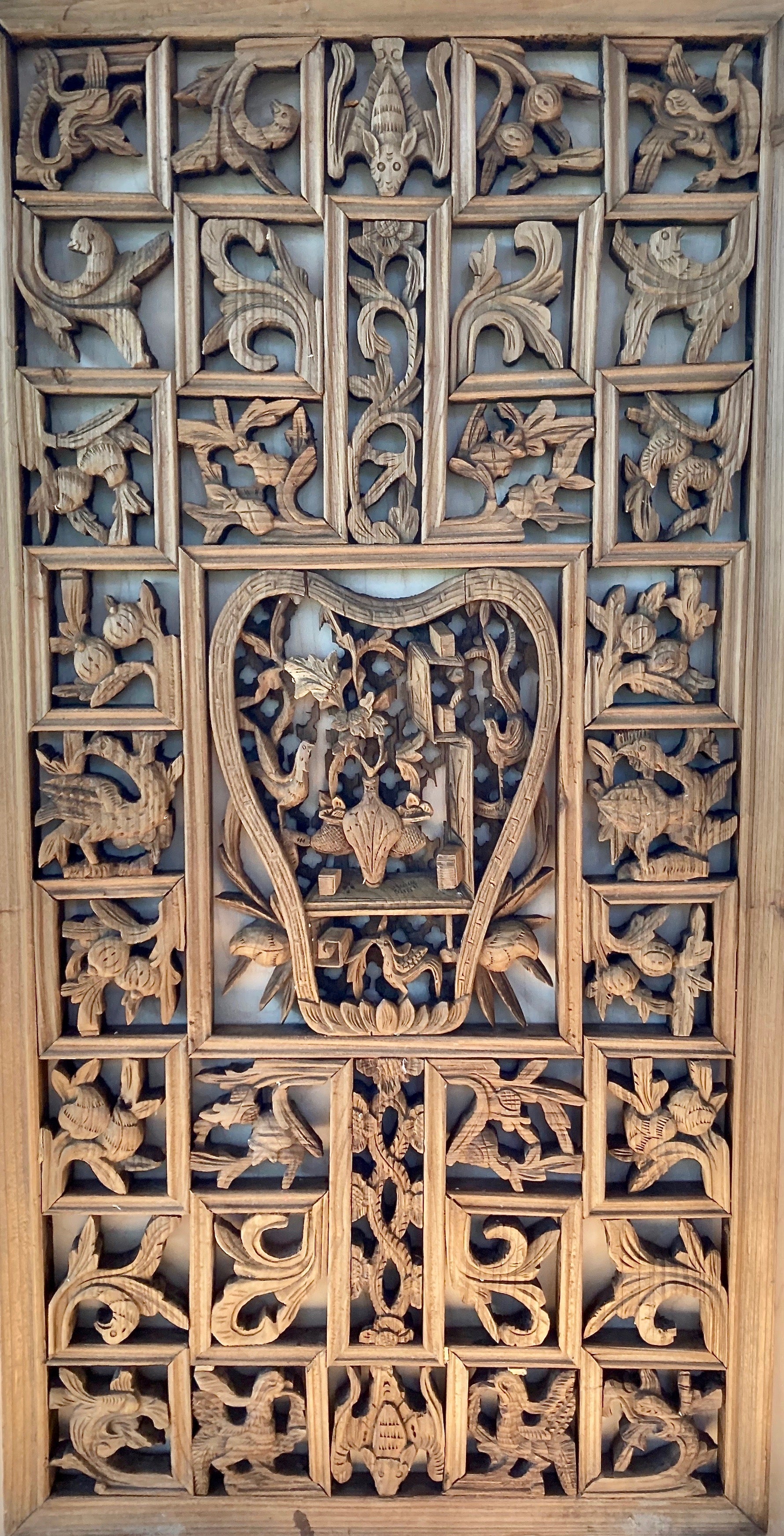 This Chinese decorative lattice work panel, has pear shaped center carving with floral, beast, personage motif. Surrounding small rectangular lattices in symbolic floral and bat motif carvings.