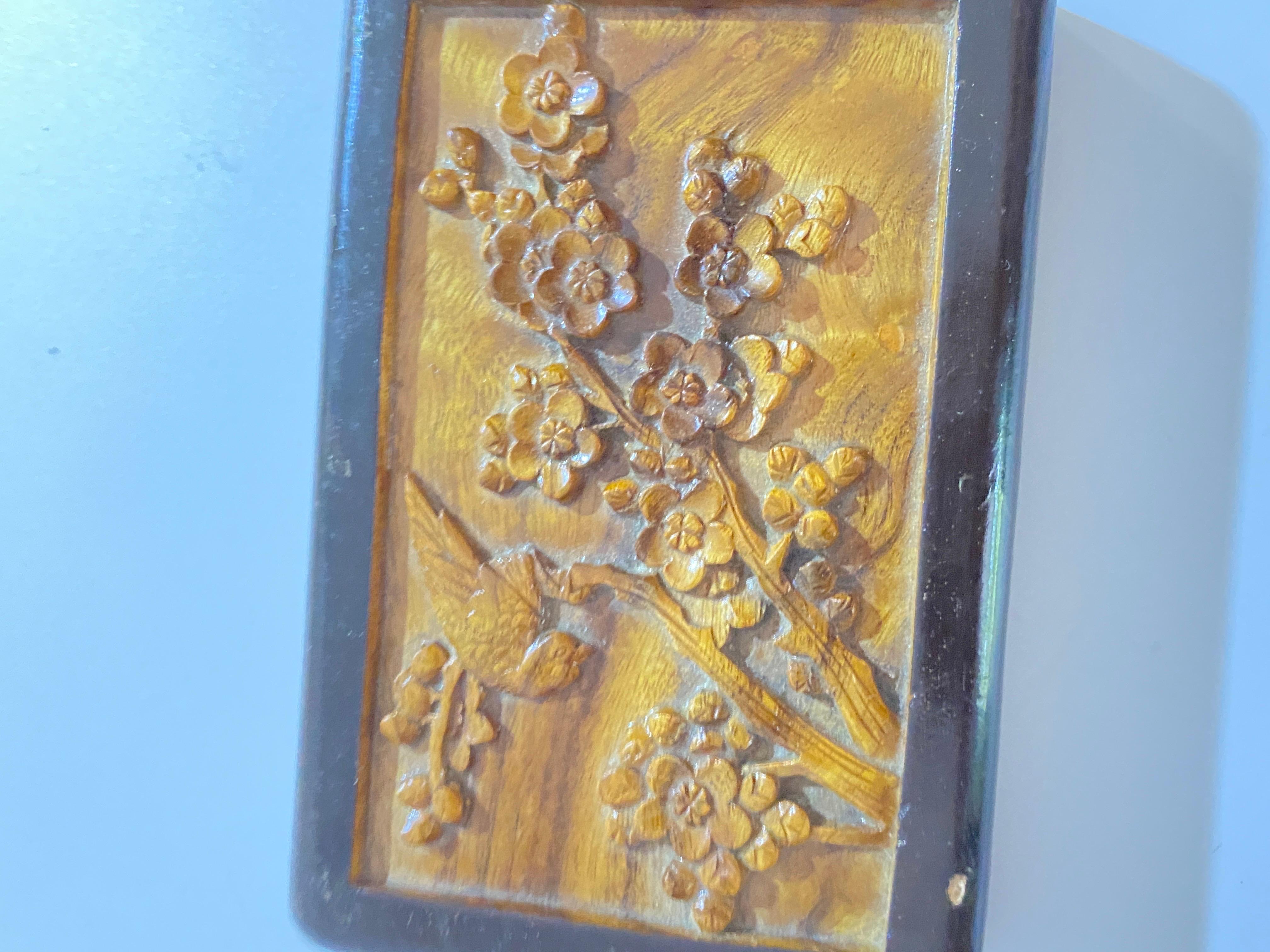 It is a carved wooden box, brown and black. One part is hand carved, the other Painted lacquered. It was made in China during the 1930s and 1940s, so it is from the Republic period.