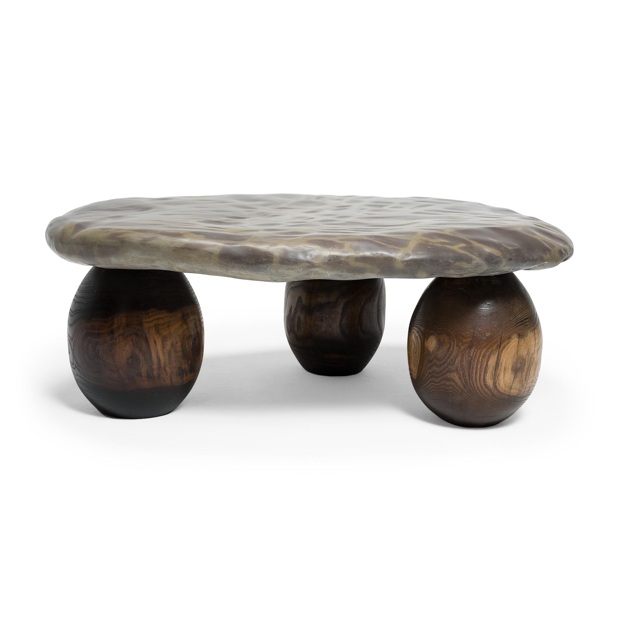 This stone top coffee table exemplifies organic modern style with its sleek design and incredible mix of natural textures. The table is comprised of a polished stone slab and a custom base of three reclaimed red oak spheres.

Mineral inclusions of