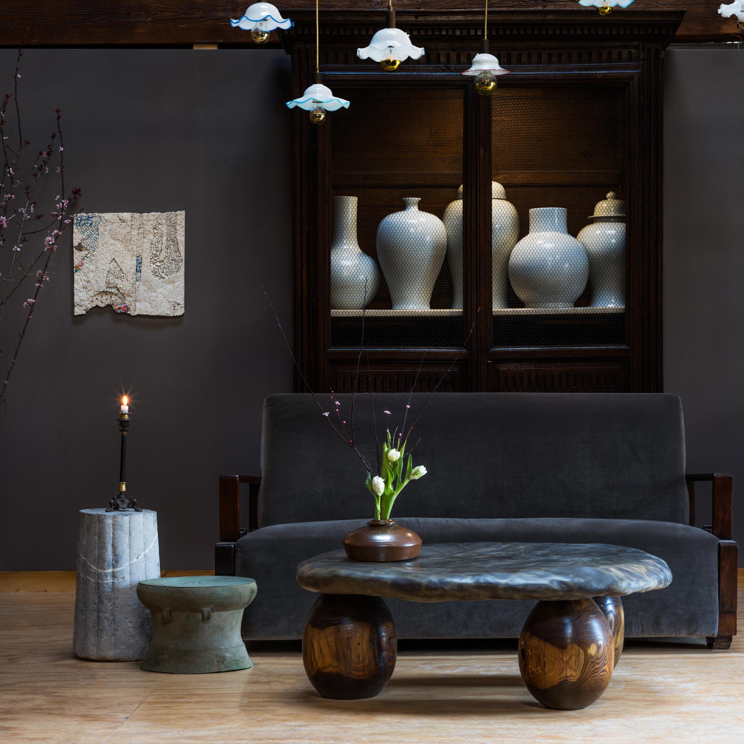 This stone top coffee table exemplifies organic modern style with its sleek design and incredible mix of natural textures. The table is comprised of a polished stone slab and a custom base of three reclaimed red oak spheres.

Mineral inclusions of