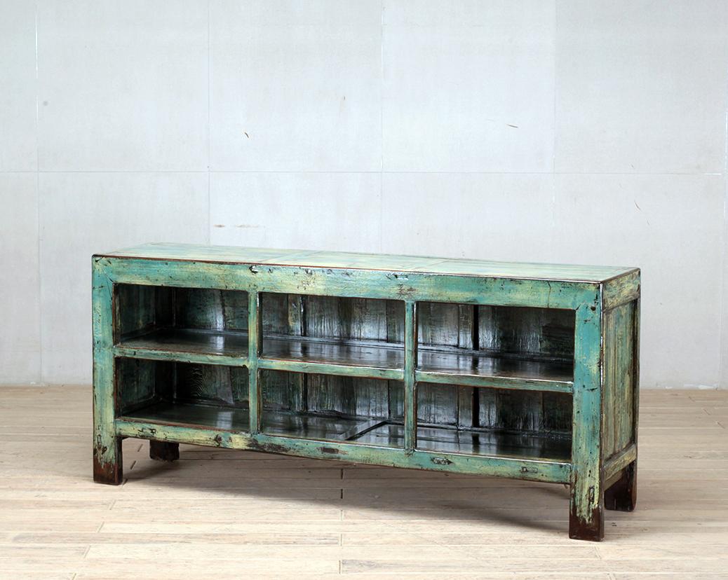 This display cabinet was made from reclaimed pine wood with traditional nail-less joinery. The piece still has a turquoise color that is still visible and has been enhanced with a sophisticated French polish finish. The piece was restored in a