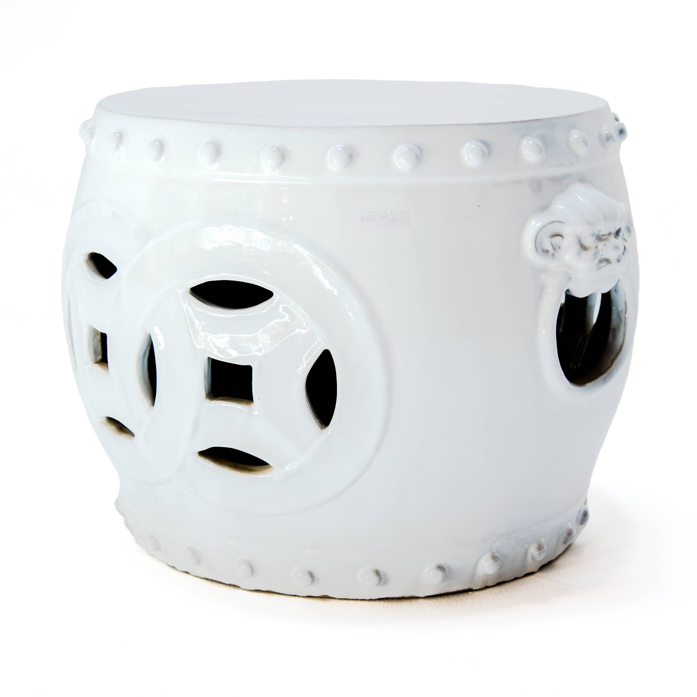 This unusually proportioned ceramic table from China’s Jiangxi province is a modern interpretation of the classic drum-form garden stool. Cloaked in a pristine, monochrome white glaze, the wide stool is decorated with bands of imitation nails, fu