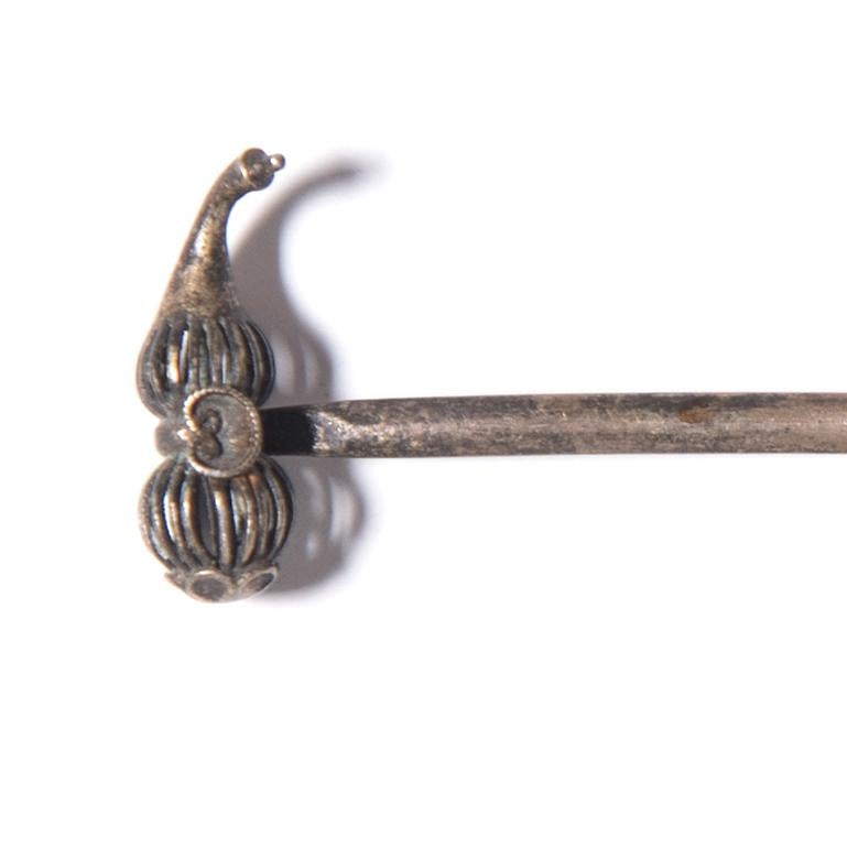 Although eyes were certainly drawn to the high, fan-shaped headdresses that Qing-dynasty women affixed to back of their heads, it was the finishing touch of a hairpin or two that completed the look. This silver hairpin ends in a minuscule