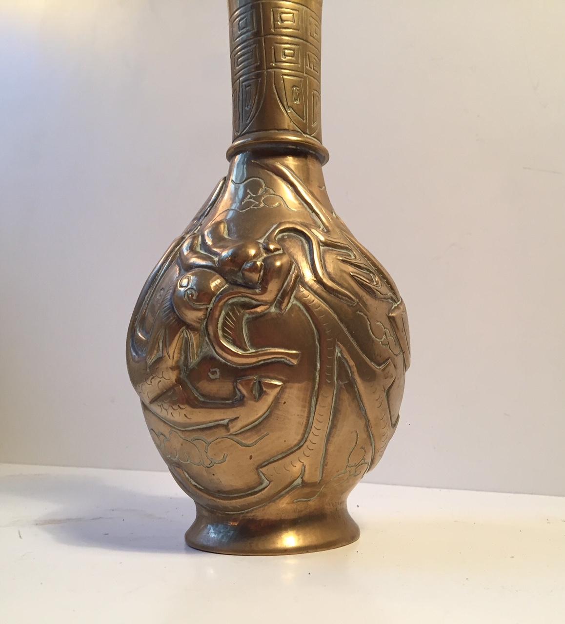 A vintage Chinese vase in Brass. The decorations are handmade. Its signed by an unidentified maker to the base. It was made for export purposes during the early-mid 20th century.