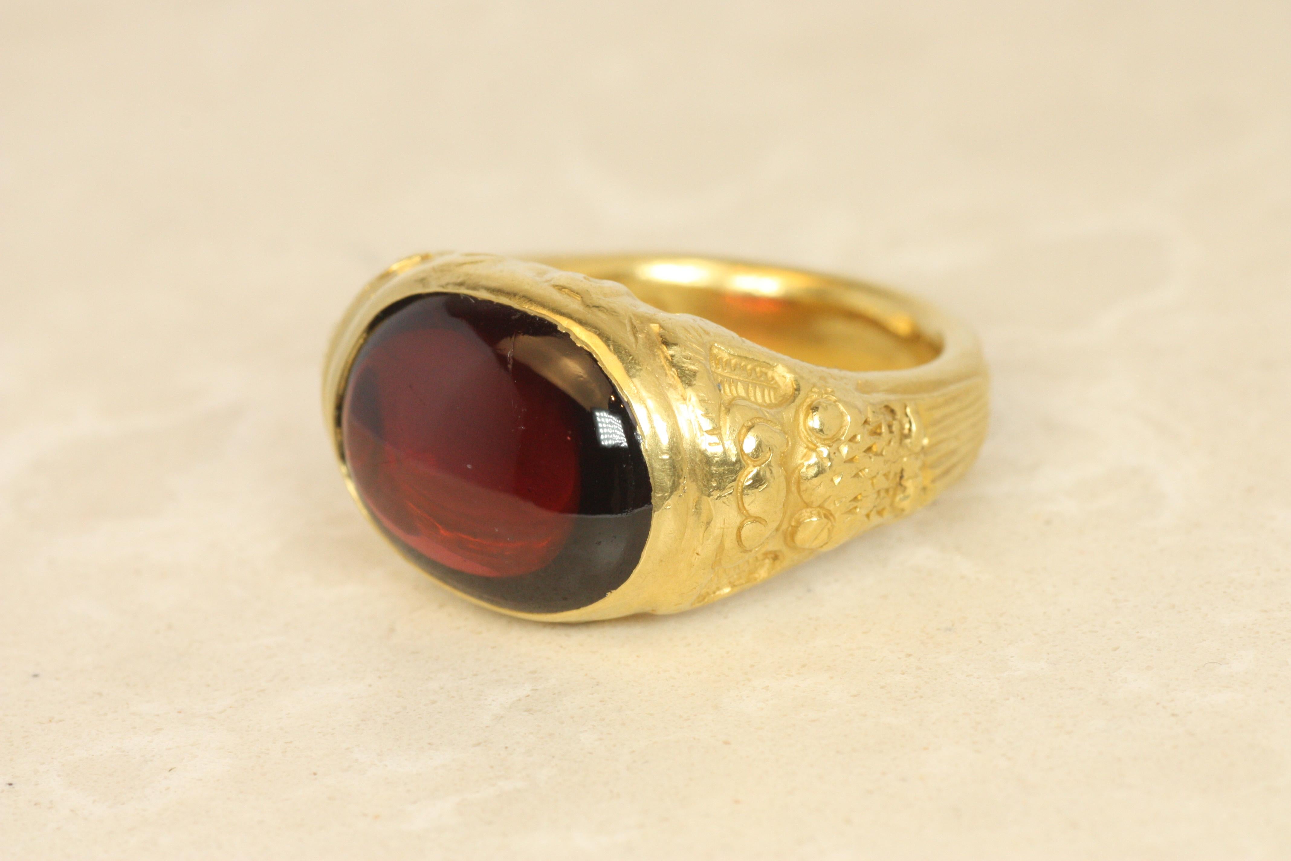 This estate ring, part of the Darlene deSedle collection by Todd Bracken, features a fiery garnet cradled in rich 22K yellow gold. Inspired by Chinese mythology, the ring’s intricate design pays homage to the strength and wisdom of the dragon,
