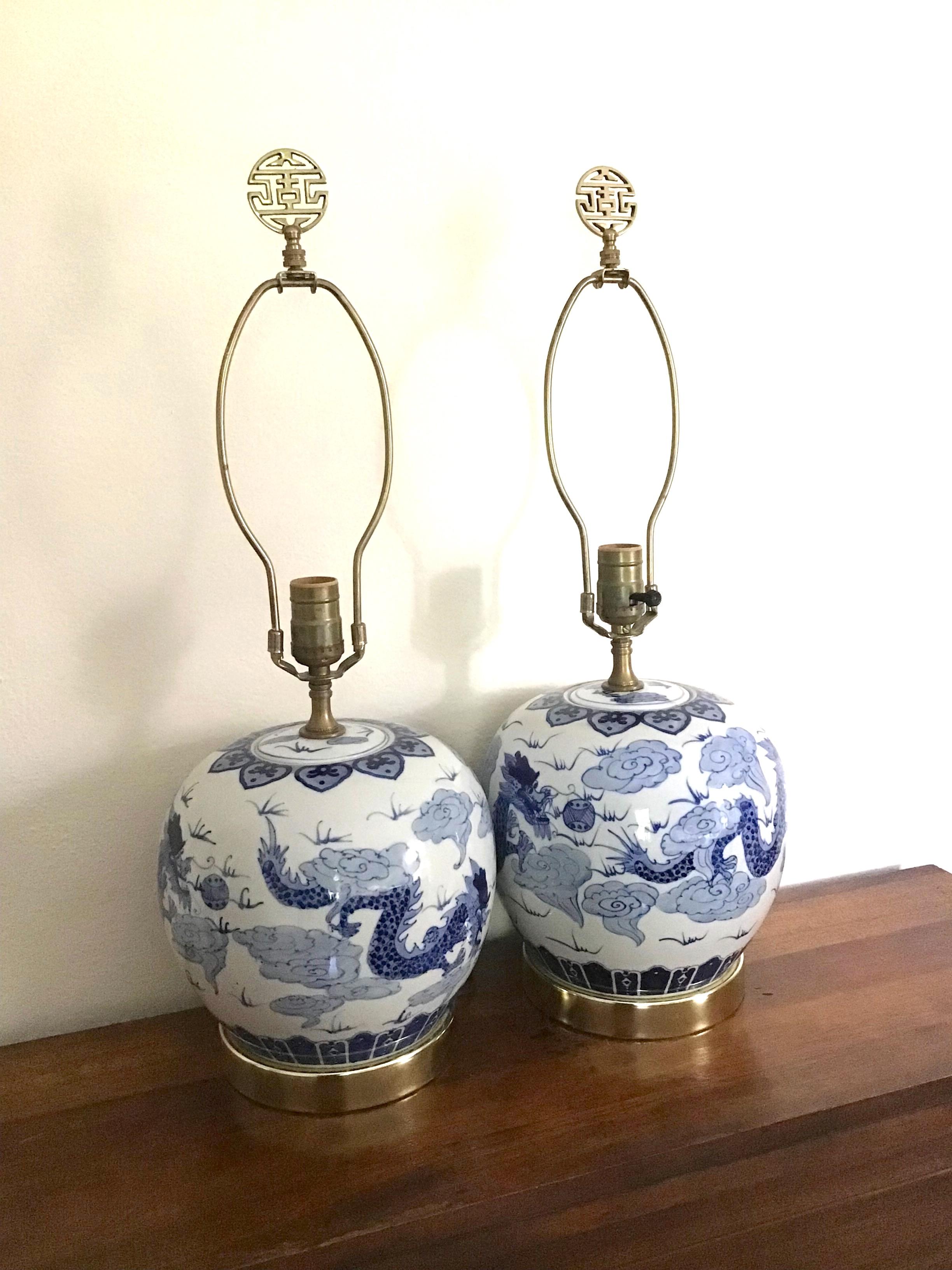 Lovely vintage ginger jar table lamps in blue and white with dragon motifs. These look to be from the 1970's from the hardware and cord.
They are in good vintage condition with no cracks to the porcelain.