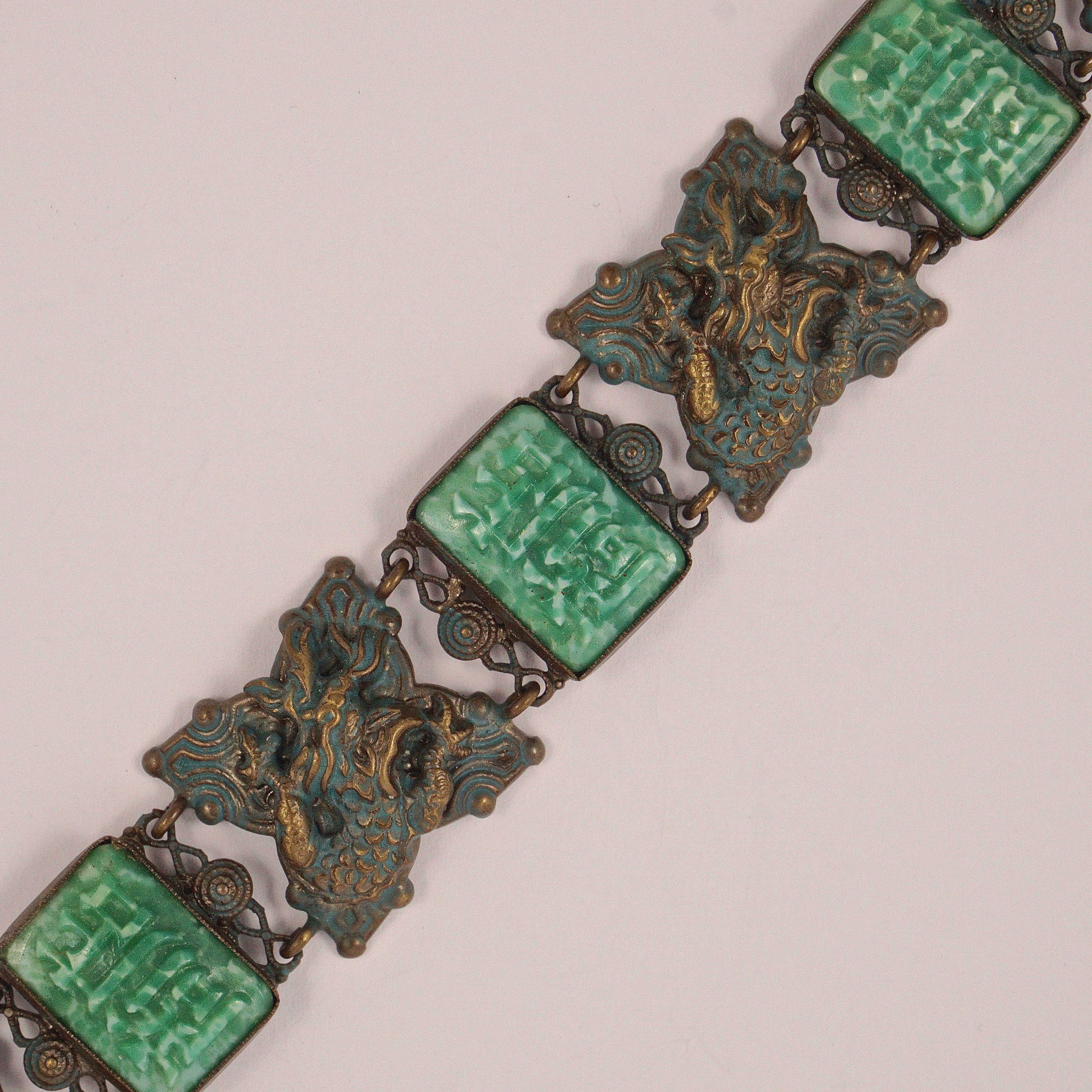 Wonderful bronze tone Chinese bracelet, with detailed dragons hand painted in gold and blue enamel, and oblong peking glass links. It has double link connectors, and a spring bolt clasp which is a little stiff but works well. Measuring length 18.7cm