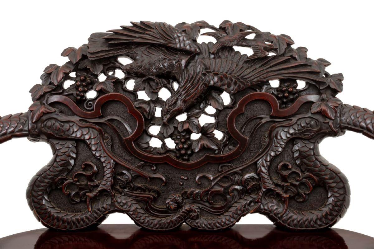 Chinese Dragon and Phoenix Motif Carved Wood Settee, with dragon head arms and floral carvings on the back above five scroll form legs, in cherry-tone finish. 41.5