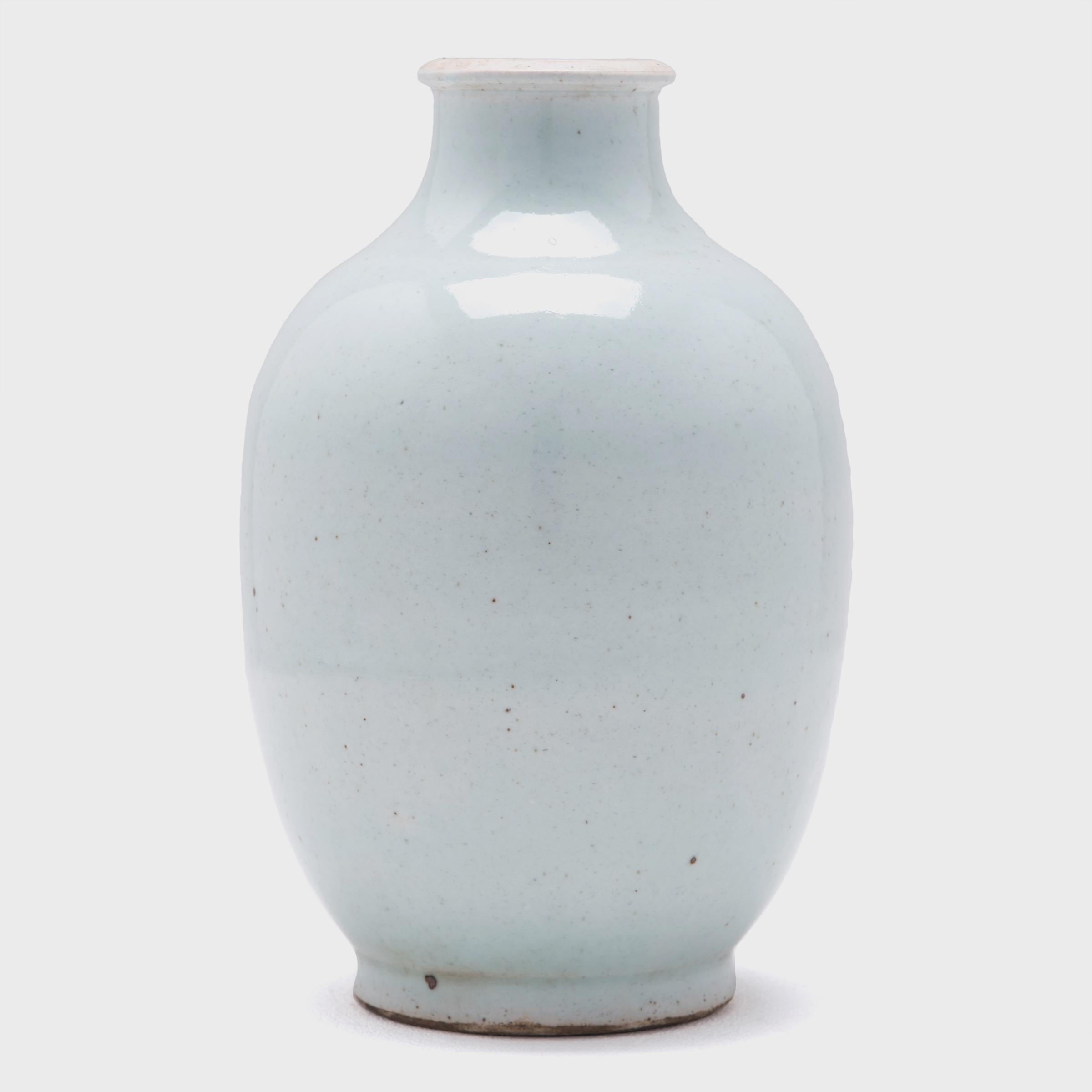 The simple, austere beauty of this exquisite wine jar is deceiving. Creating this jar, with its perfectly tapered form and cool-toned drip cloud glaze, would have required the artisan to master the ancient art of Chinese porcelain making. The