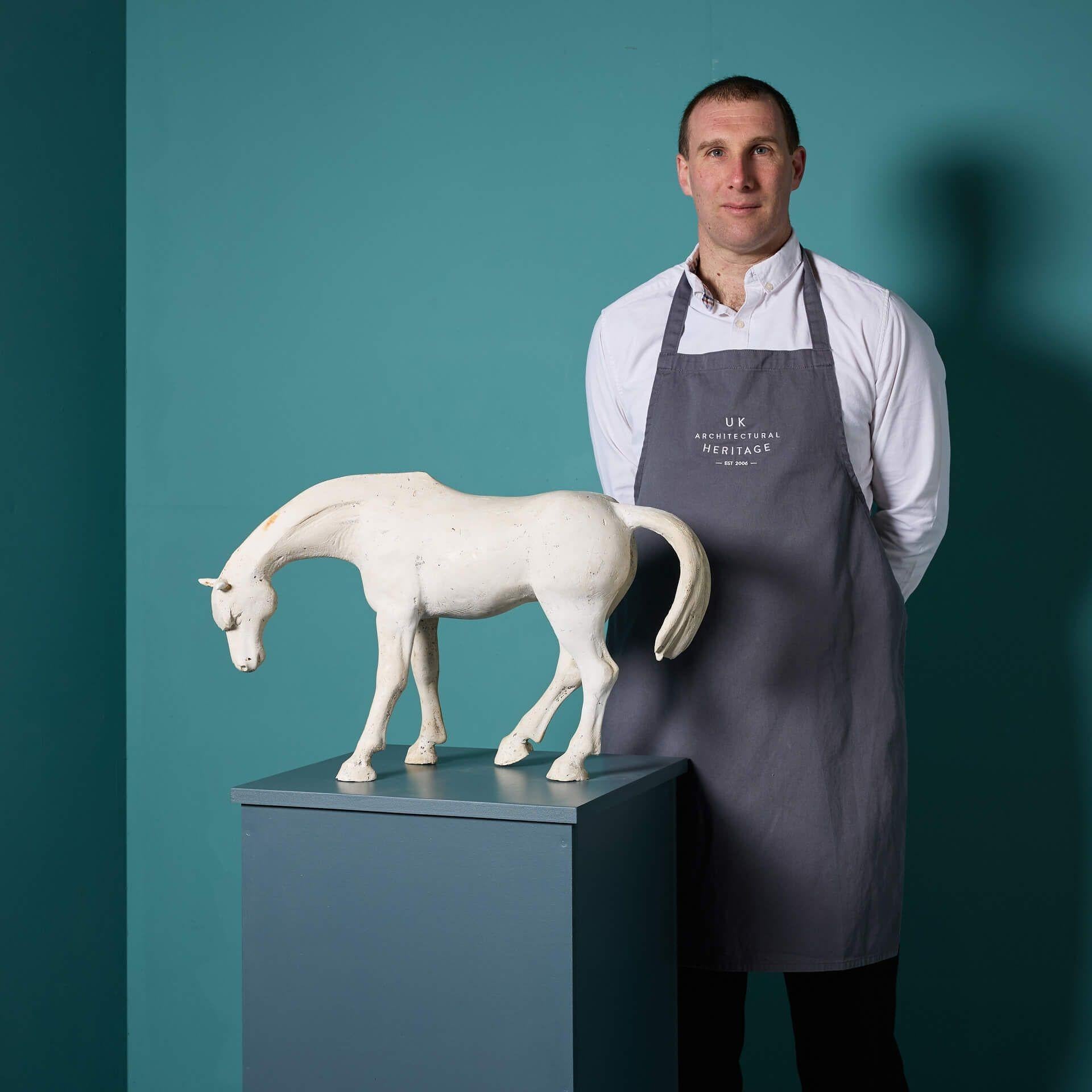 A striking sculptural plaster maquette of a Chinese Dynamic style horse by the acclaimed British sculptor, John W. Mills.
 
Part of the artist’s equestrian art series, this plaster maquette depicts a horse with head bowed and tail arched,