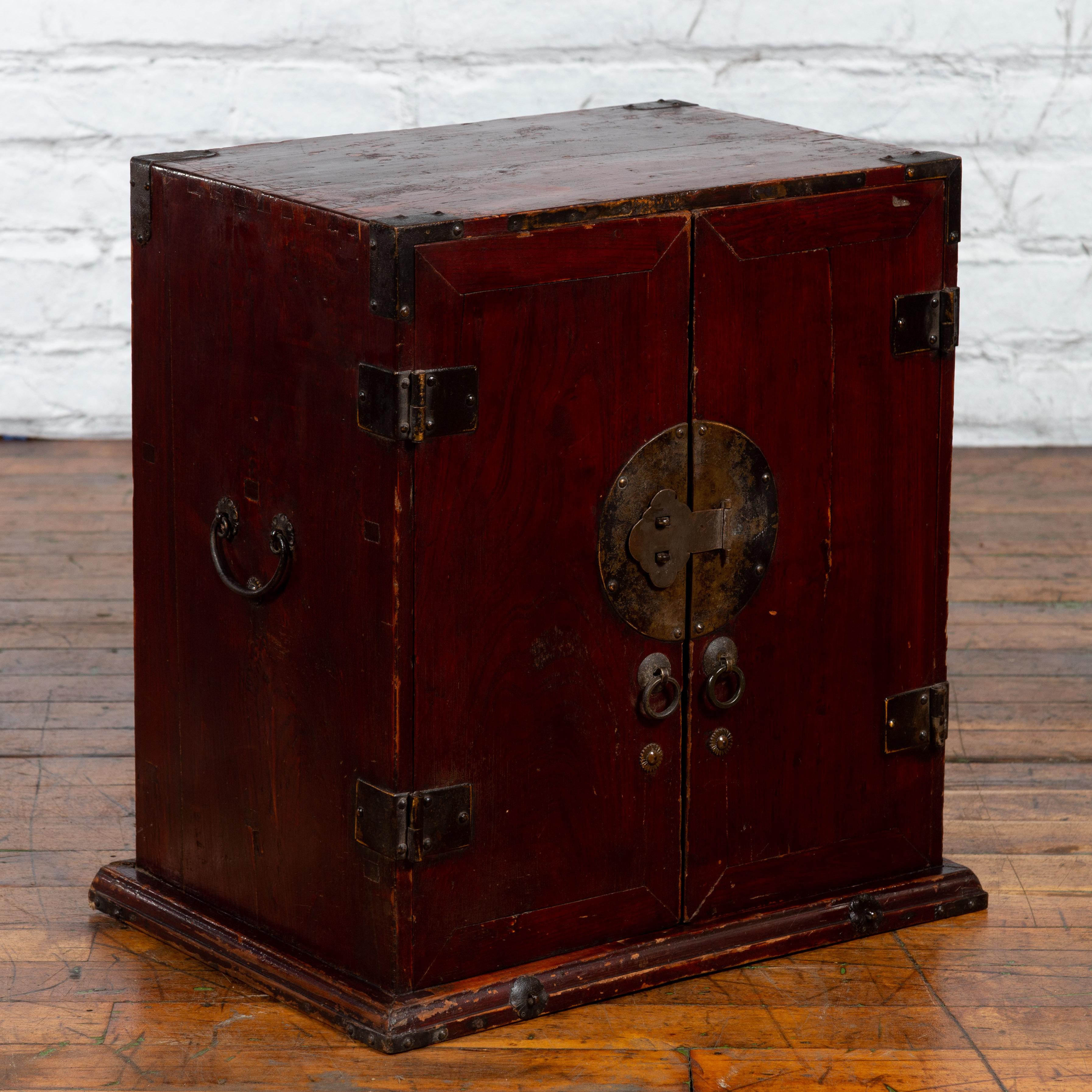Lacquered Chinese Early 20th Century Dark Red Lacquer Carrying Chest with Round Medallion