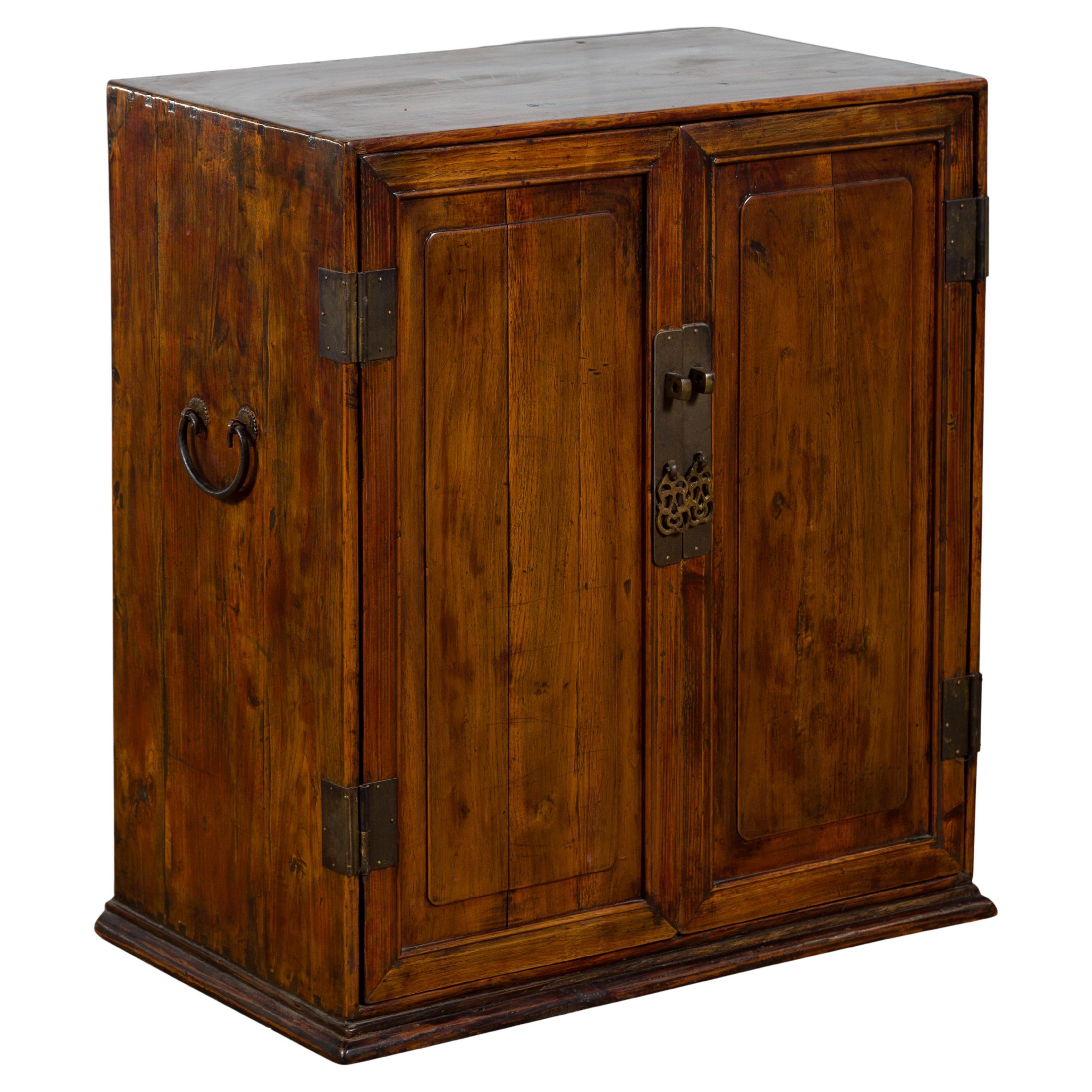 Chinese Early 20th Century Elmwood and Brass Side Cabinet with Raised Panels For Sale