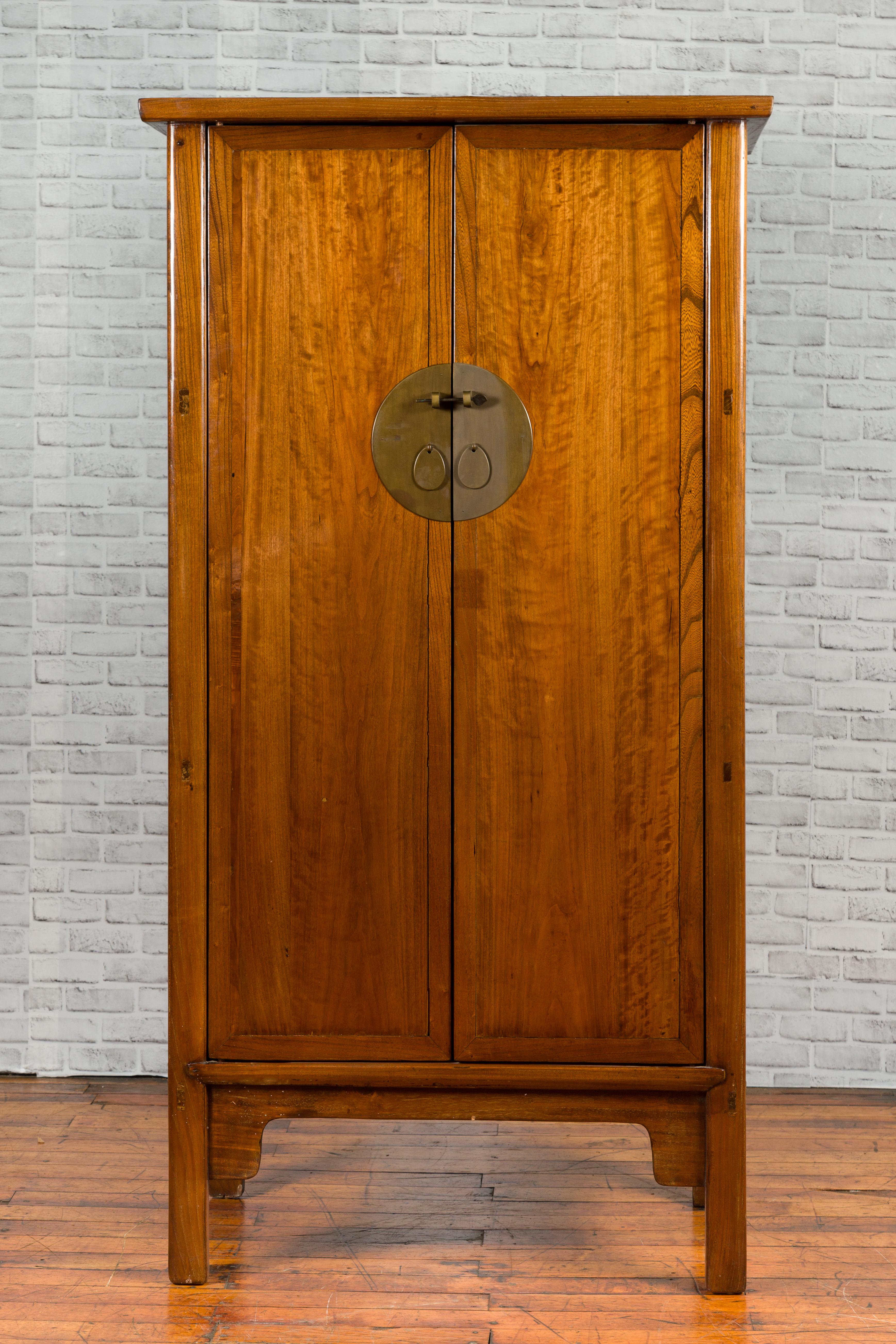 A Chinese elmwood noodle cabinet from the early 20th century, with four hidden graduated drawers and light brown lacquer. Created in China during the early years of the 20th century, this noodle cabinet features a linear silhouette perfectly