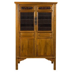 Chinese Early 20th Century Tall Cabinet with Fretwork Motifs and Carved Panels