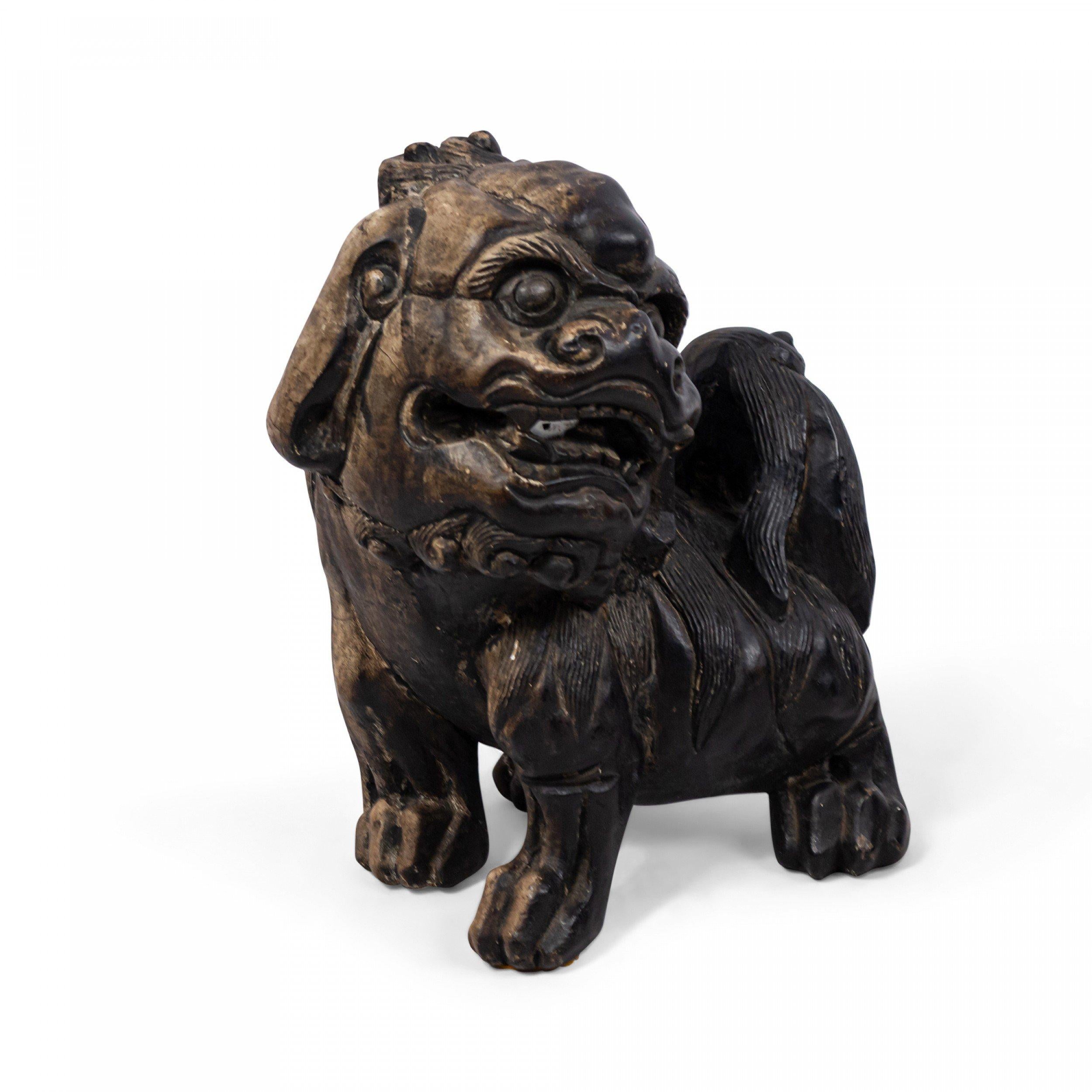 Pair of Chinese ebonized pottery foo dogs.
    