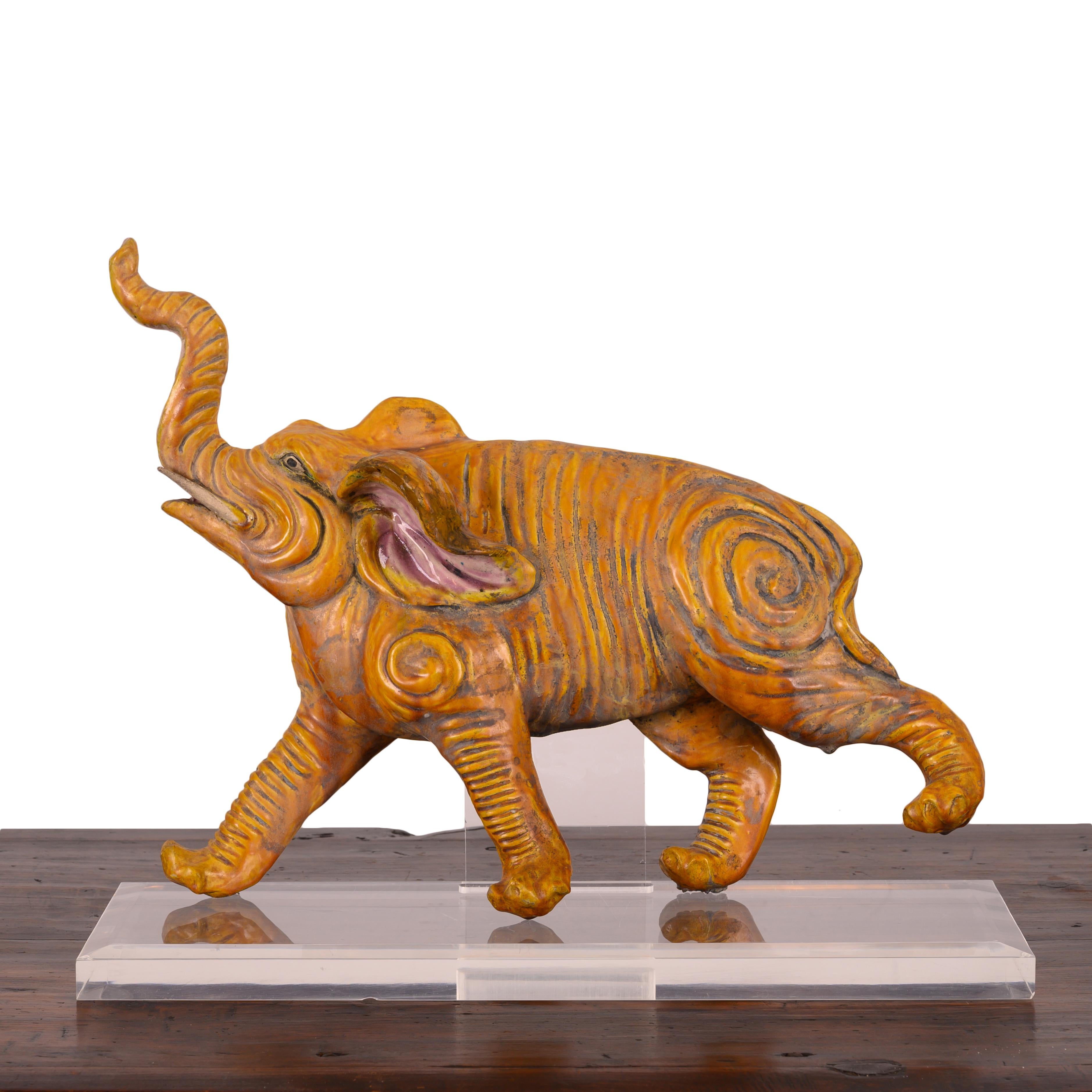 A Chinese elephant roof tile on lucite base, 19th Century.

19 ½ inches wide by 7 ½ inches deep by 15 inches tall