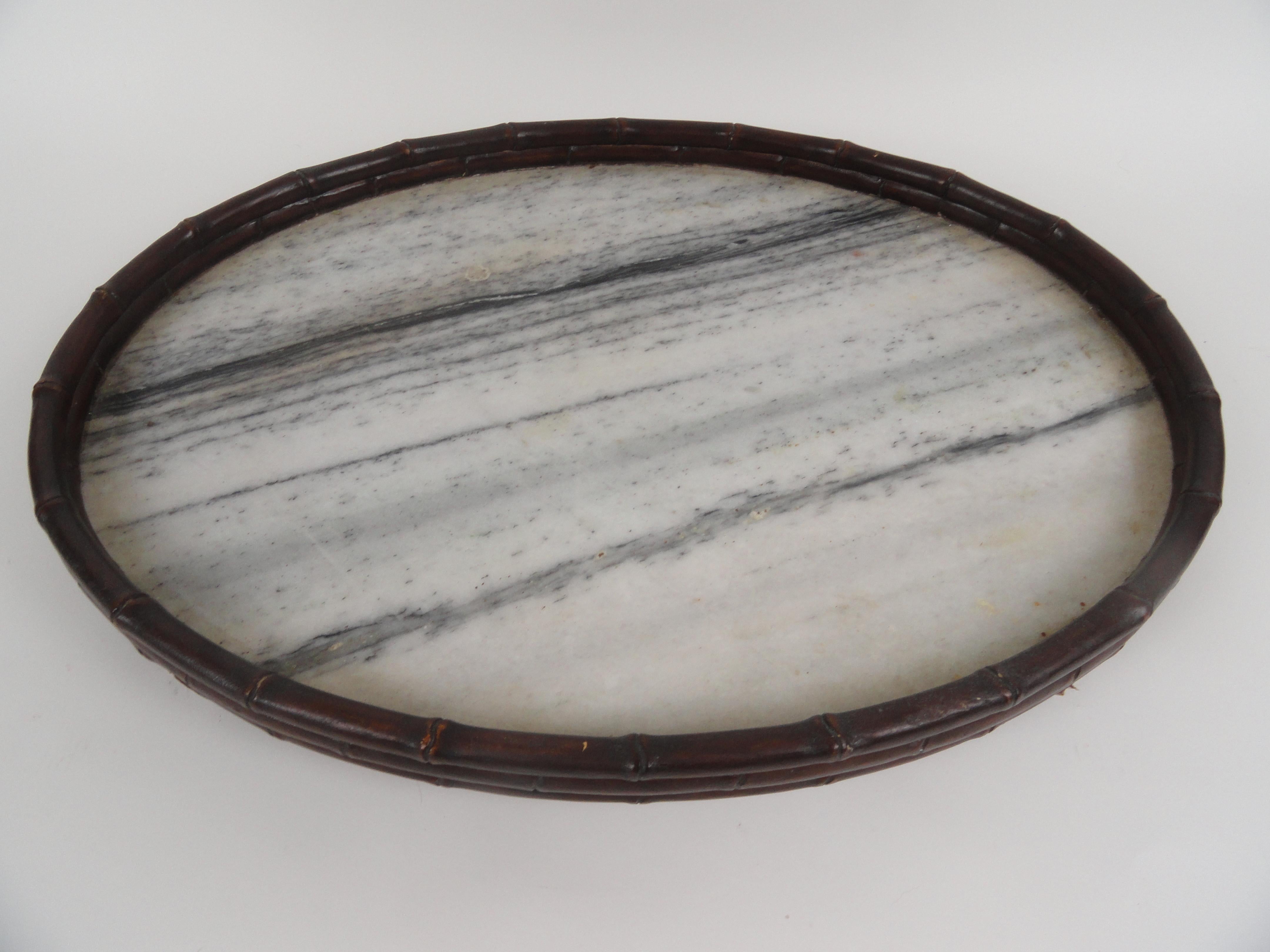 Chinese serving tray with a marble top and curved wood bamboo motif around the top and sitting four feet.