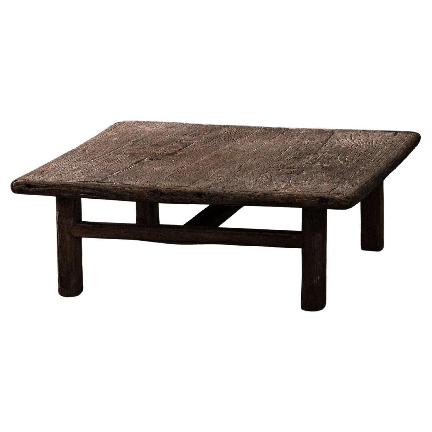 Handcrafted patinated elm coffee table. Made in China circa early 20th century.